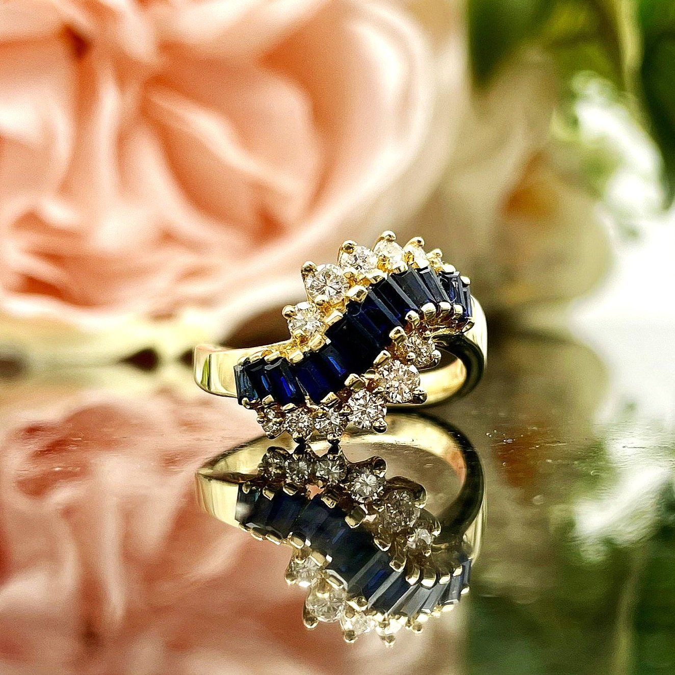 close up in front of flowers Unique Sapphire And Diamond 14k Yellow Gold Ladies Ring