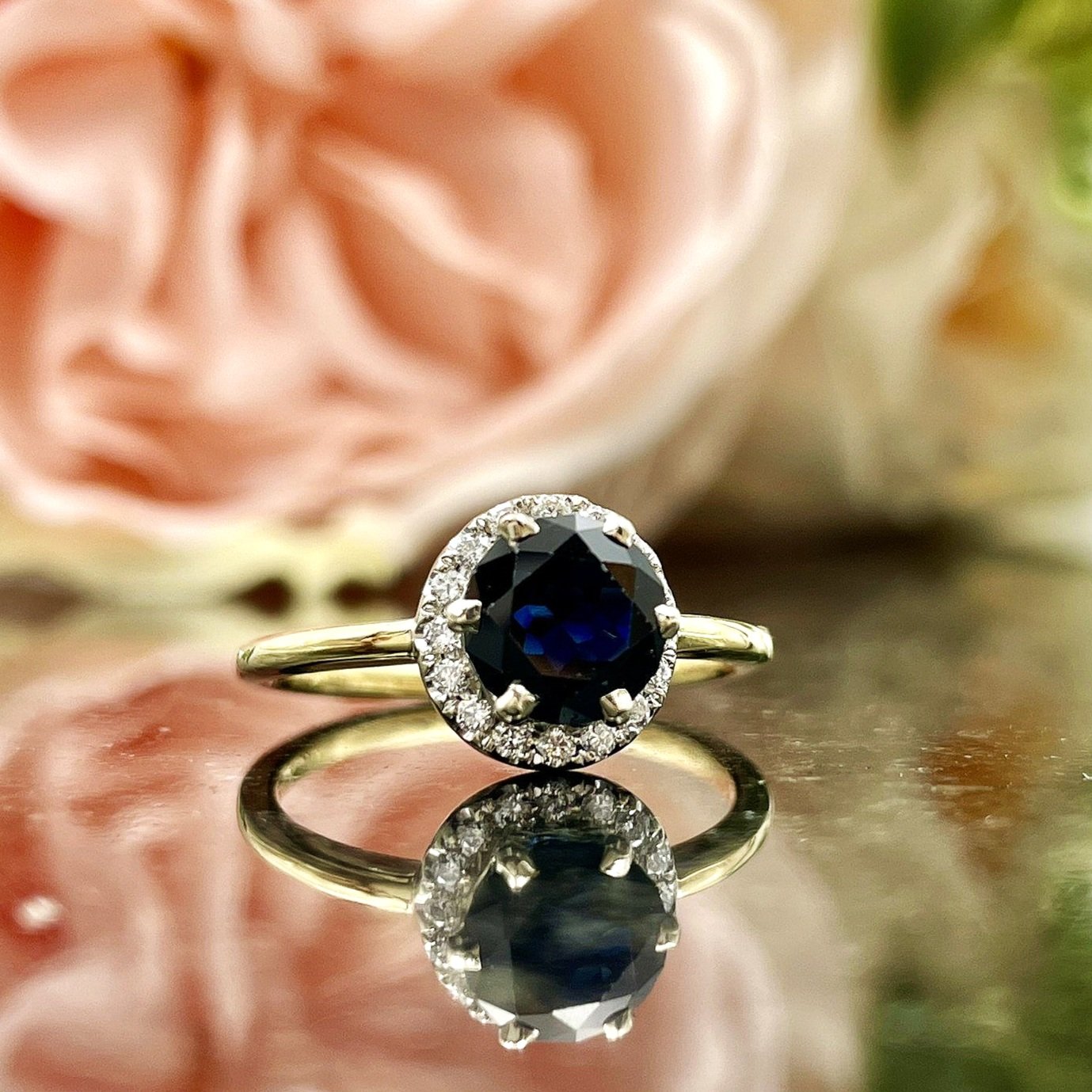 close up in front of flowers 1.29ct Sapphire With Diamond Halo Ladies Ring 14k Two Tone Yellow And White Gold