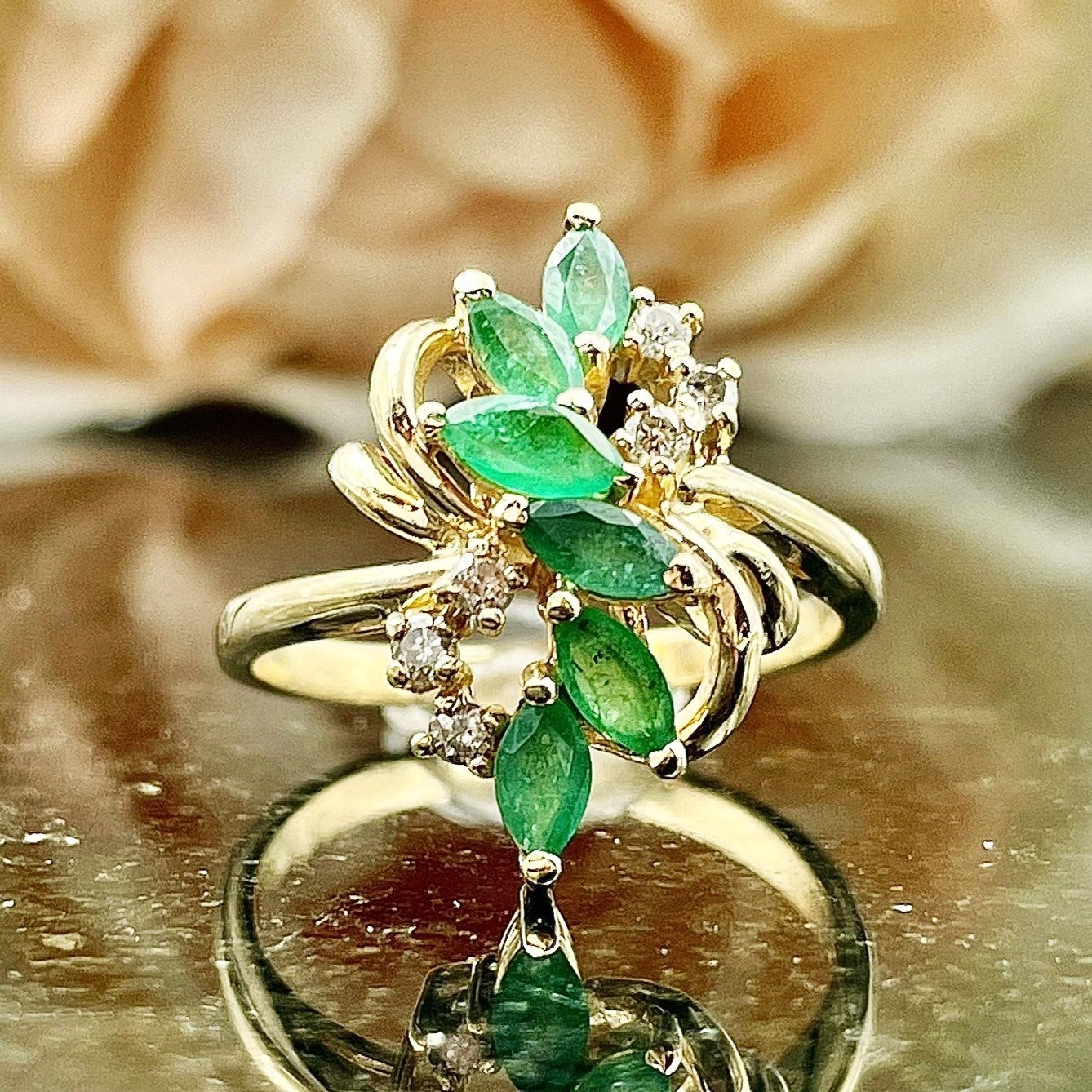 close up in front of florals Marquise Cut Emerald With Diamond Accents Vintage Inspired Statement Ring 14k Yellow Gold