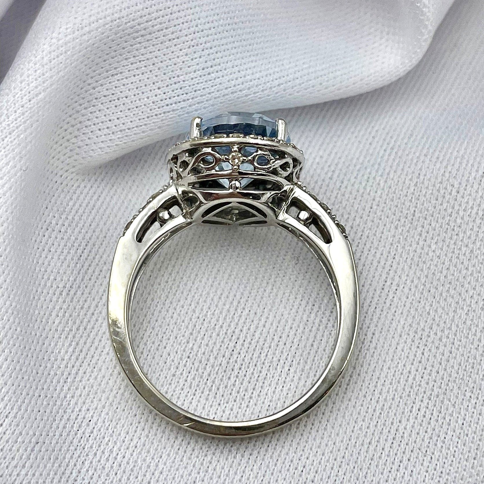 top down gallery view Oval Blue Topaz With Diamond Halo And Split Shoulders 14k White Gold Ring