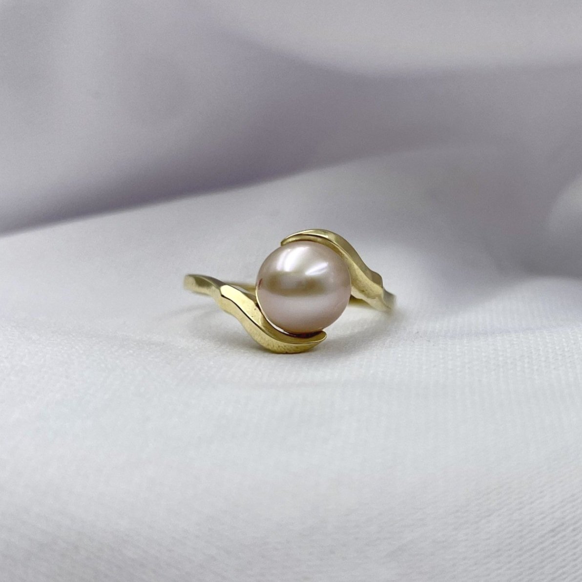 14k Yellow Gold Filigree Cutout Ladies Pearl Fashion Ring close up in front of white cloth