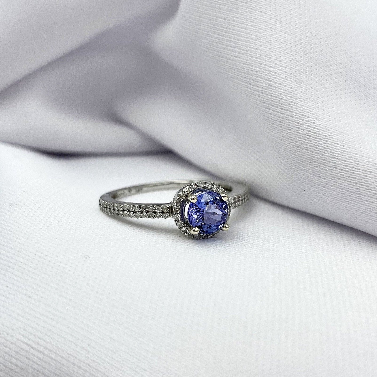 3/4 close up white background Tanzanite With Diamond Halo Diamond Band Ladies 14k White Gold Ring