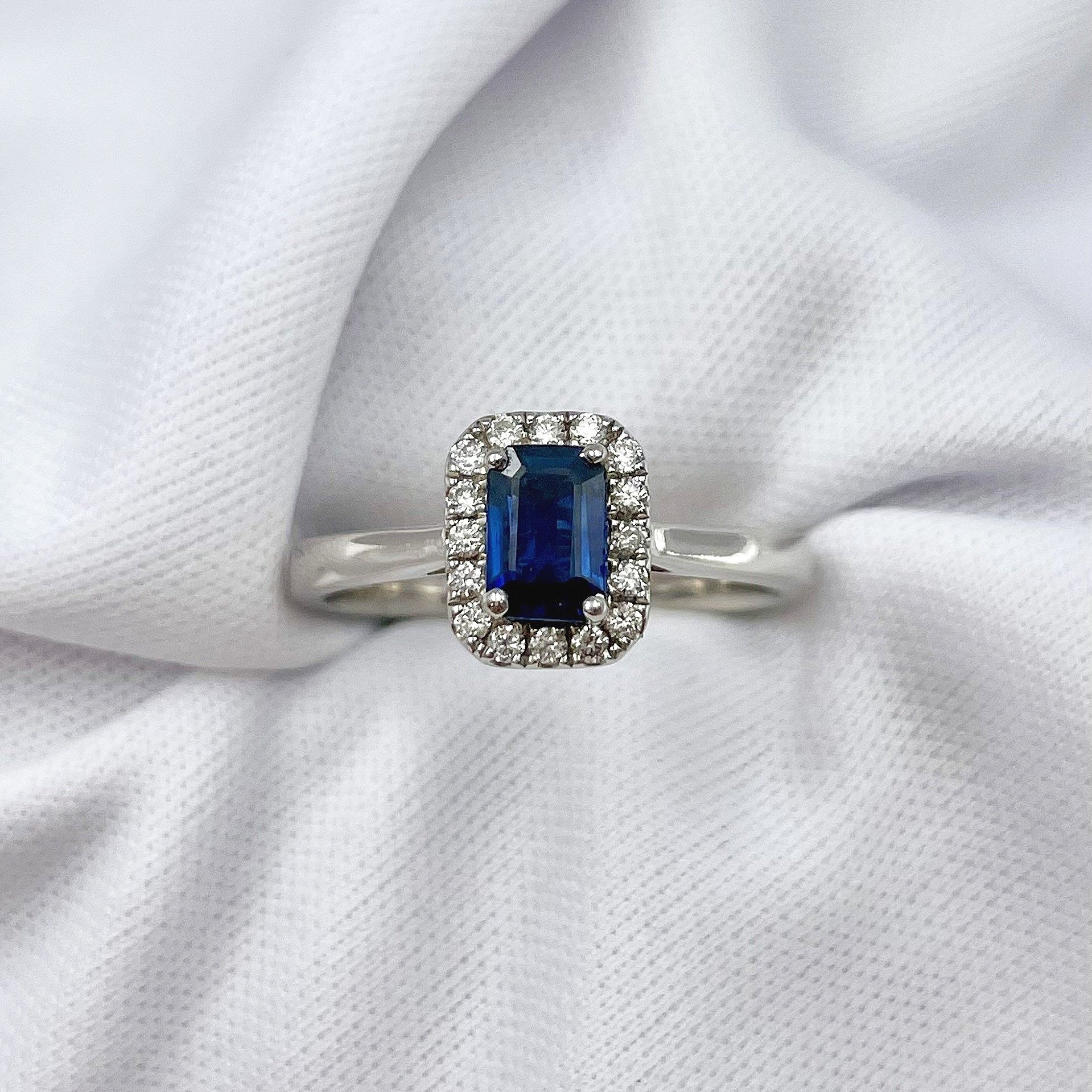 top down view white background .64ct Emerald Cut Sapphire With Diamond Halo Ladies Ring 14k White Gold