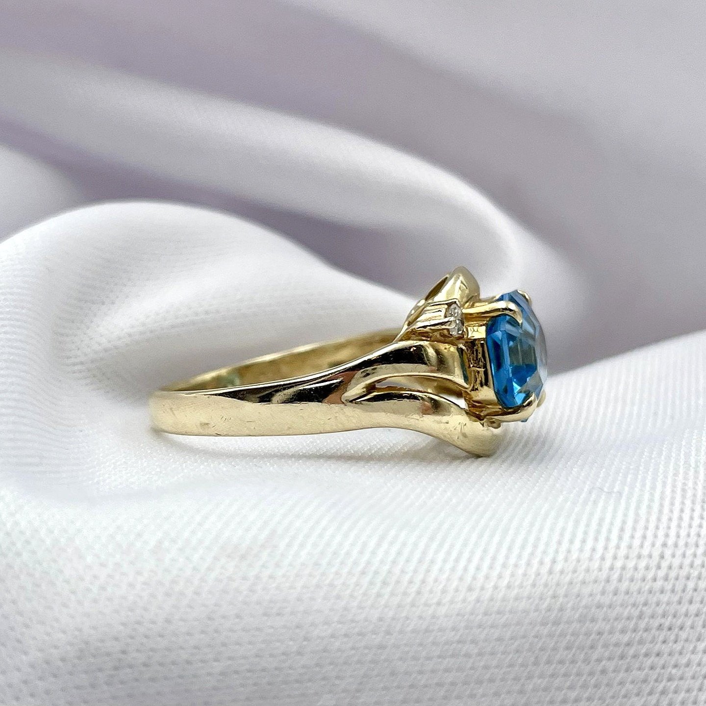 side view white background Octagonal Cut Blue Topaz With Diamond Accents Swirl 14k Yellow Gold Ladies Ring