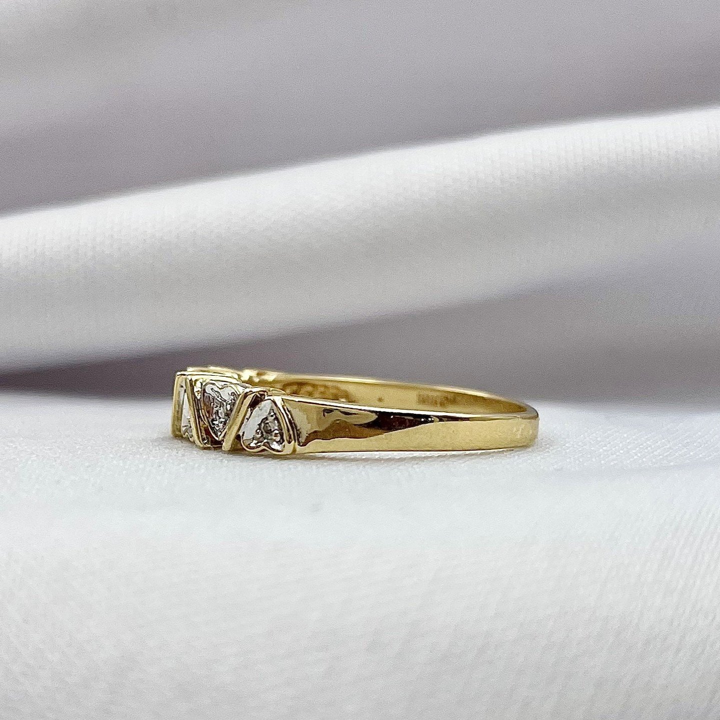 side view white background 10k Yellow Gold Diamond Accent Heart Band