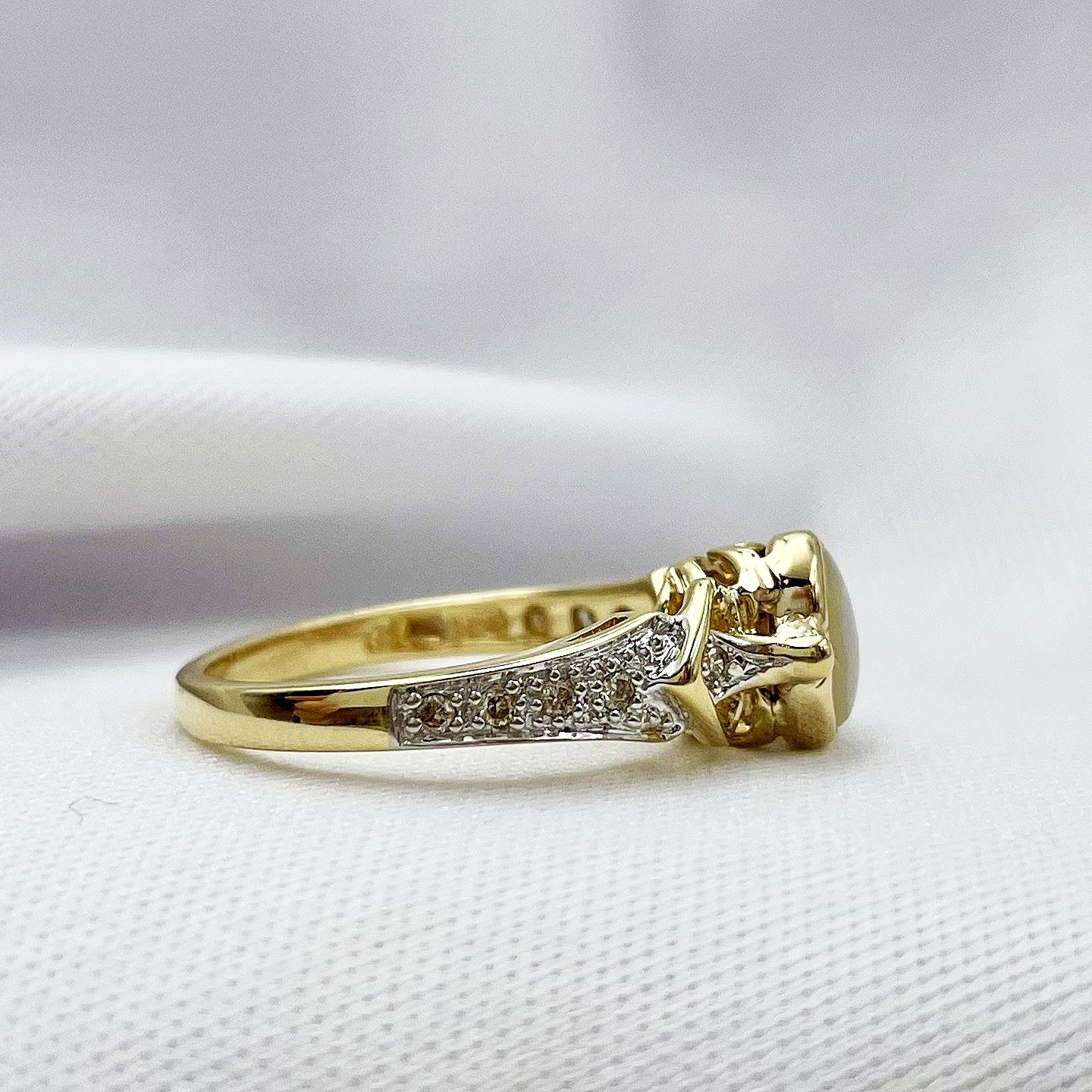 side view white background 10k Yellow Gold Bezel Set Oval Opal With Diamonds Ladies Ring