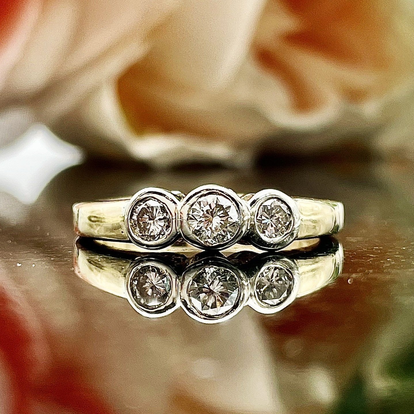 close up in front of flowers 1/2ctw 3 Stone Bezel Set Anniversary Right Hand Ring 14k Yellow Gold