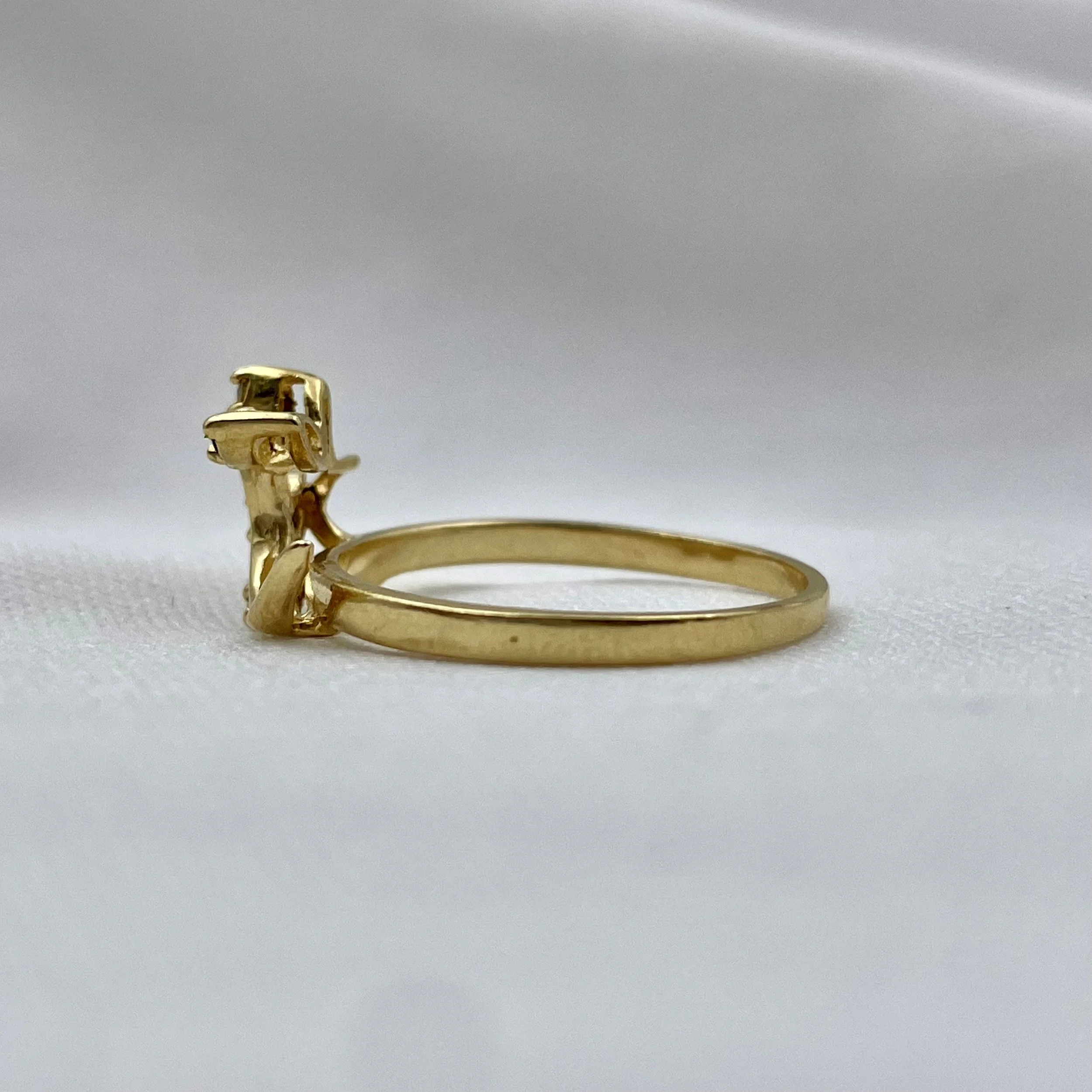 side view of 14k Yellow Gold Sapphire And Diamond Leaf Wrap Wedding Band white cloth background