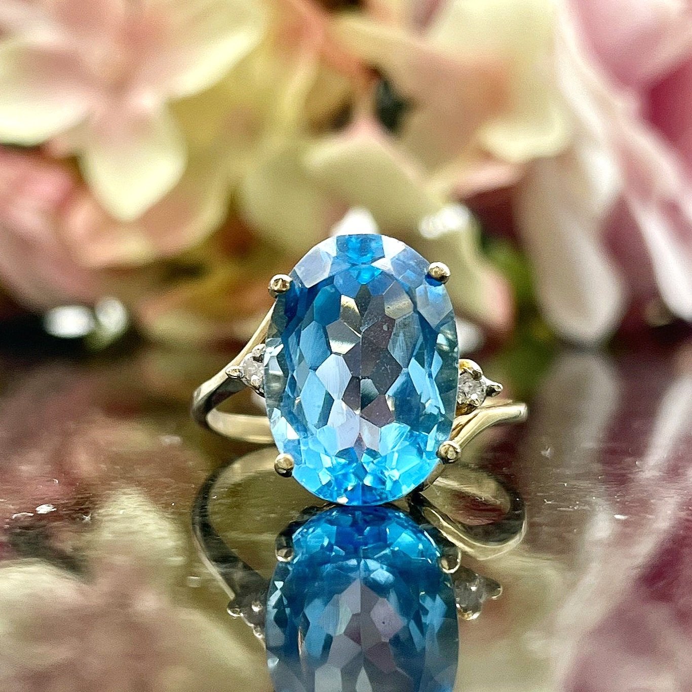 close up in front of flowers 14k Yellow Gold Bypass Topaz And Diamond Ladies Statement Ring