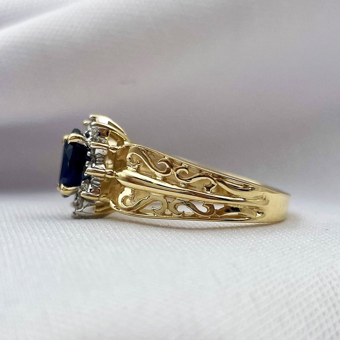 side view white background 14k Yellow Gold Oval Sapphire With Diamond Halo Filigree Ring