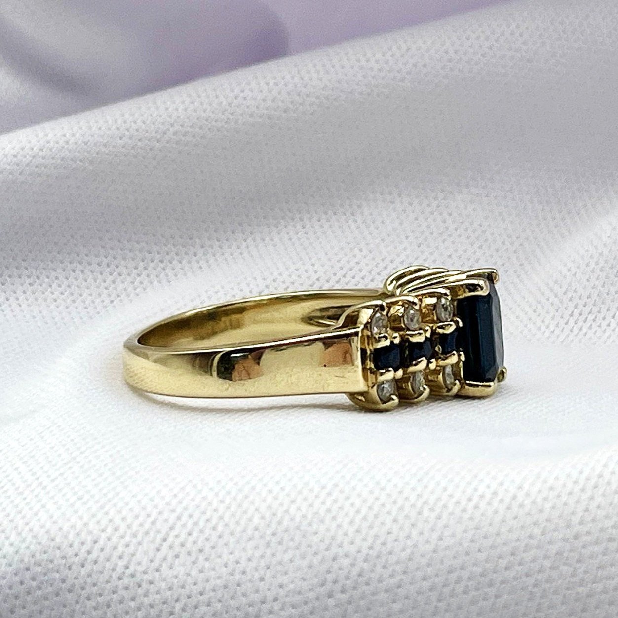 side view white background Emerald Cut Sapphire With Diamond And Sapphire Accents Ladies Ring 14k Yellow Gold