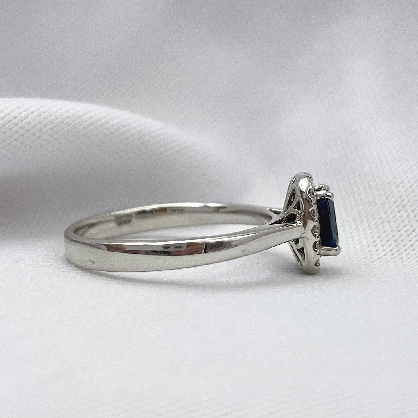 side view white background .64ct Emerald Cut Sapphire With Diamond Halo Ladies Ring 14k White Gold