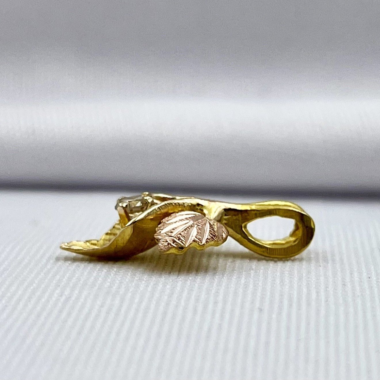 side view white background 10k Black Hills Gold .07ct Diamond Leaf Pendant