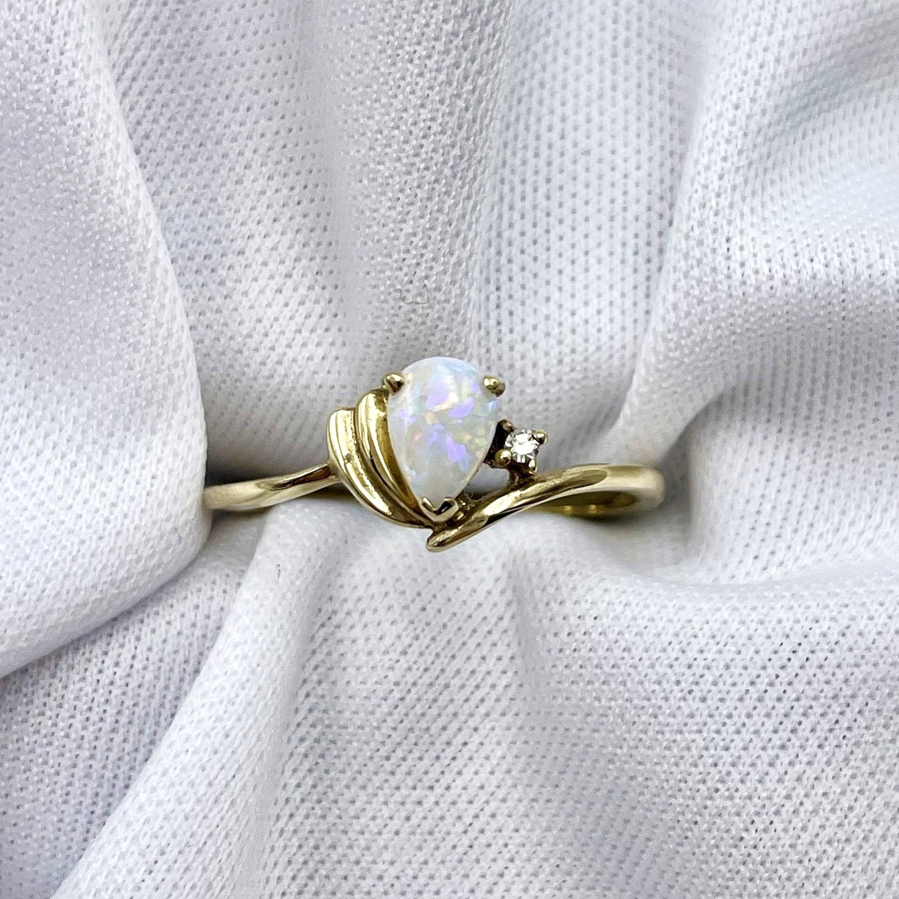 top down white background 10k Yellow Gold Pear Cut Opal With Diamond Accent Ladies Ring