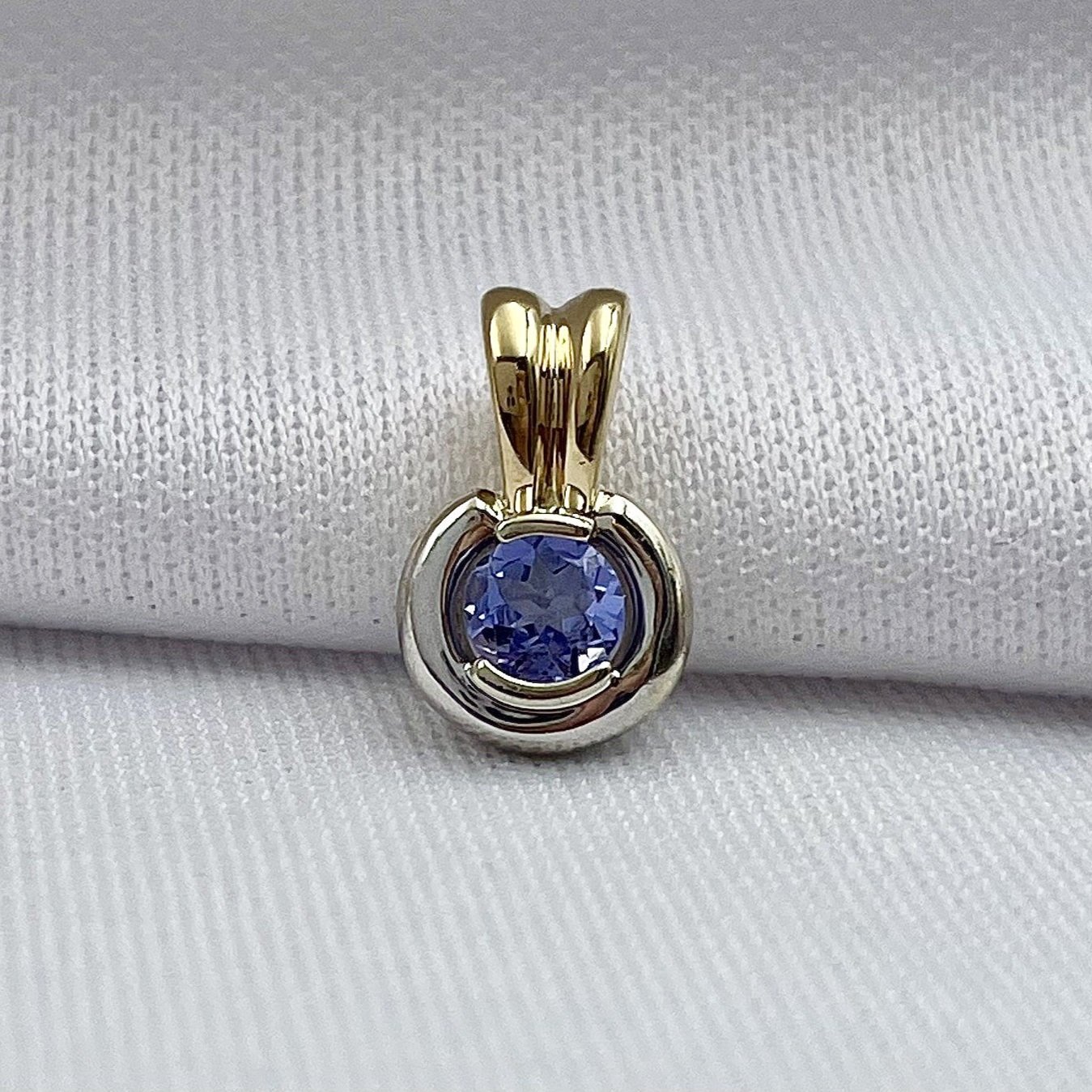 close up white background 14k Two Tone White And Yellow Gold Half Bezel Set Tanzanite Solitaire Pendant