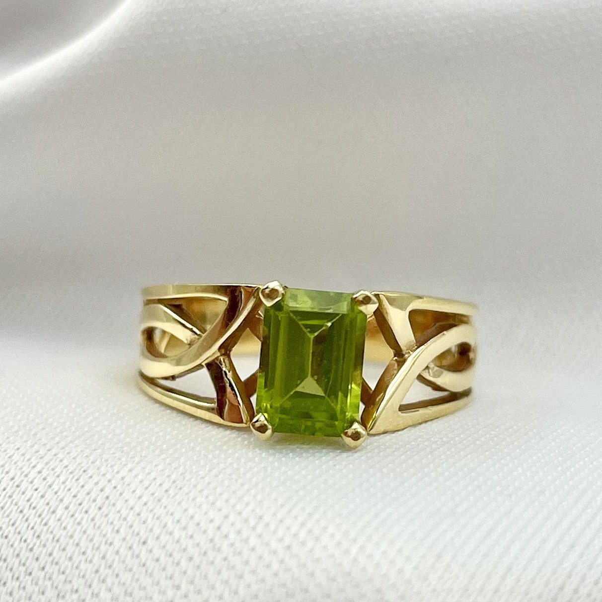 close up white background Peridot Emerald Cut Celtic Knot Inspired 14k Yellow Gold Ring