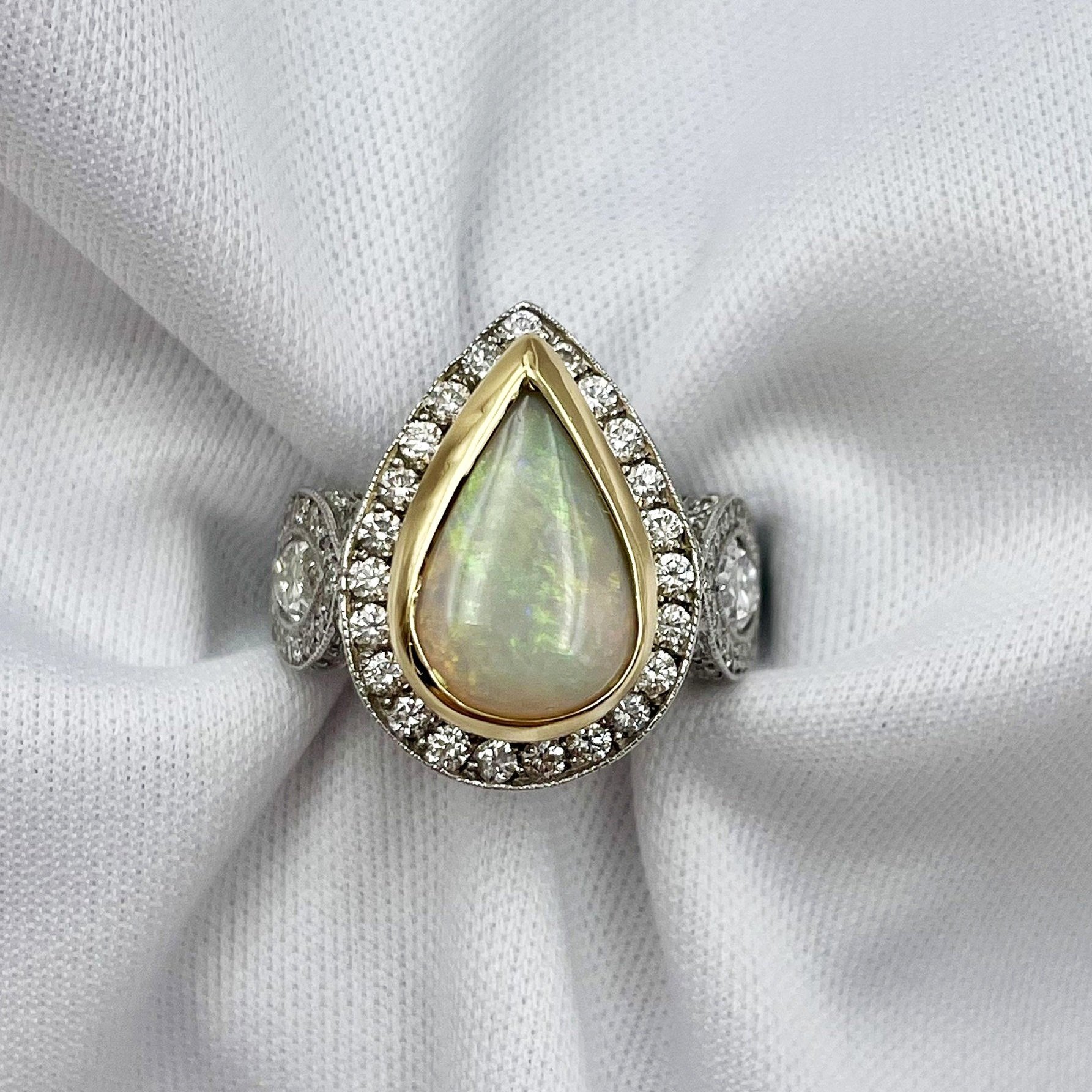 top down white background 3.01ct Pear Cabochon Bezel Set With 1.87ctw Diamond Accents in Two Tone 14k White 18k Yellow Ring