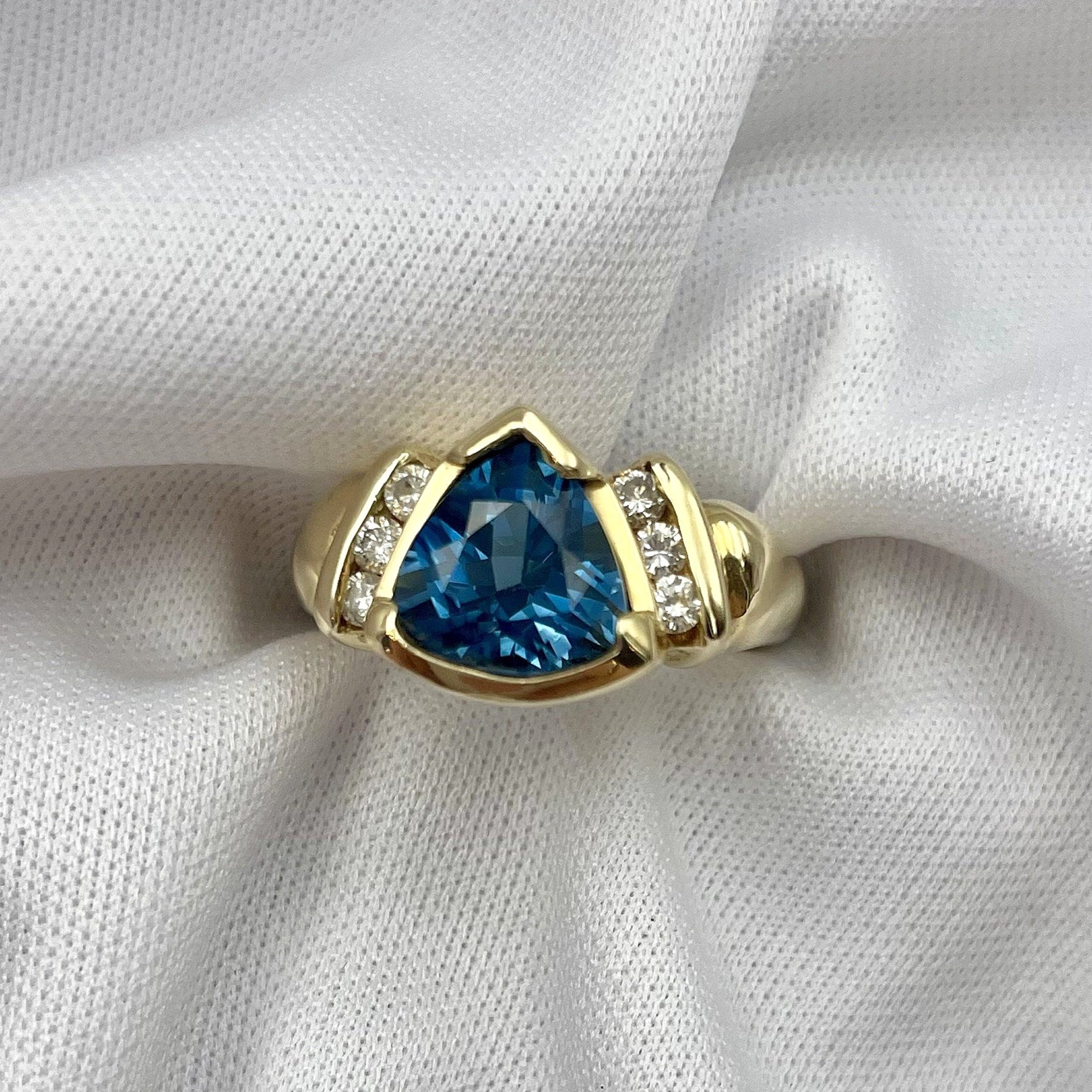top down close up white background Trillion Cut Blue Topaz With Diamond Accents Ladies Ring 14k Yellow Or White Gold