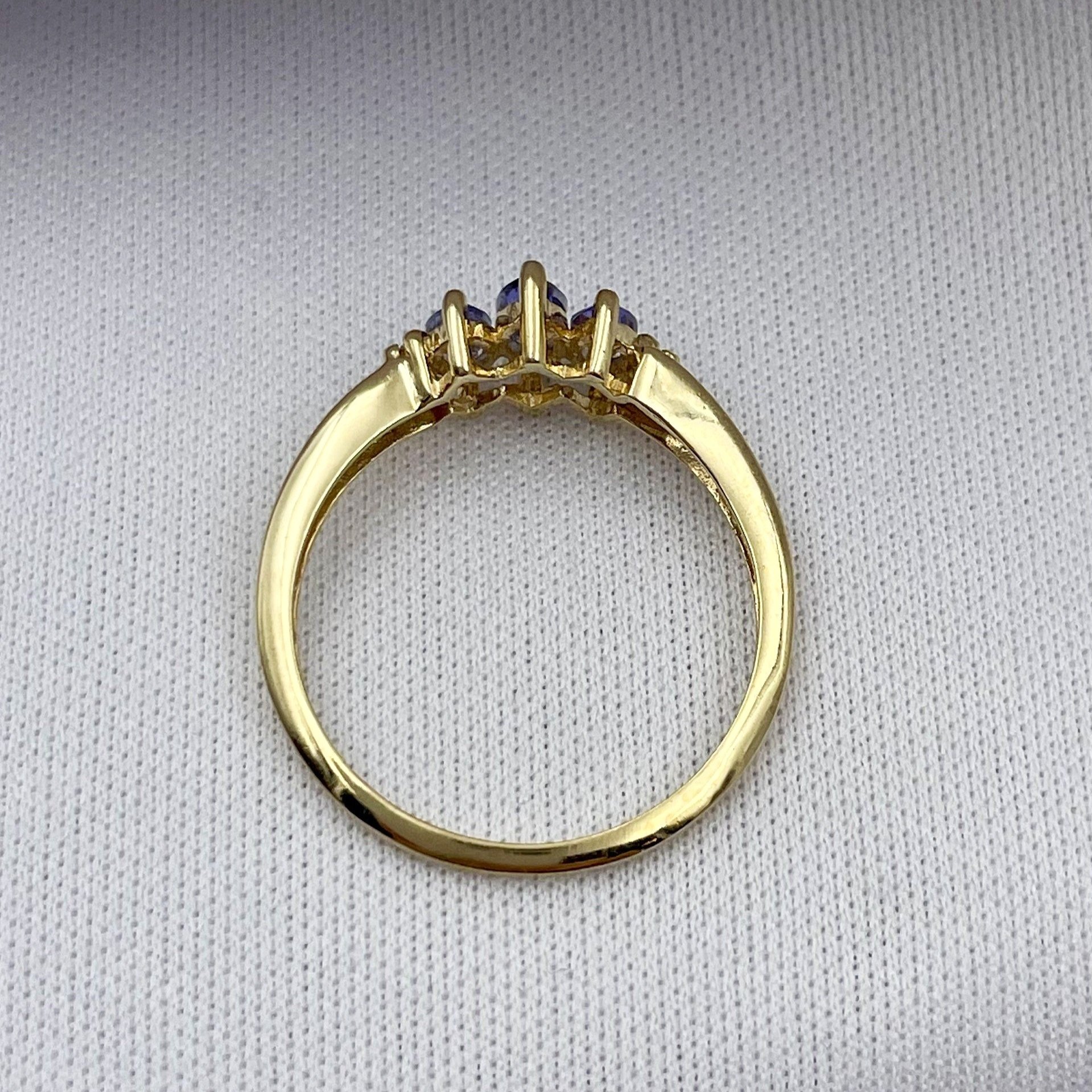 top down white background Marquise Cut Three Stone Tanzanite Ring With Diamond Accents 10k Yellow Gold