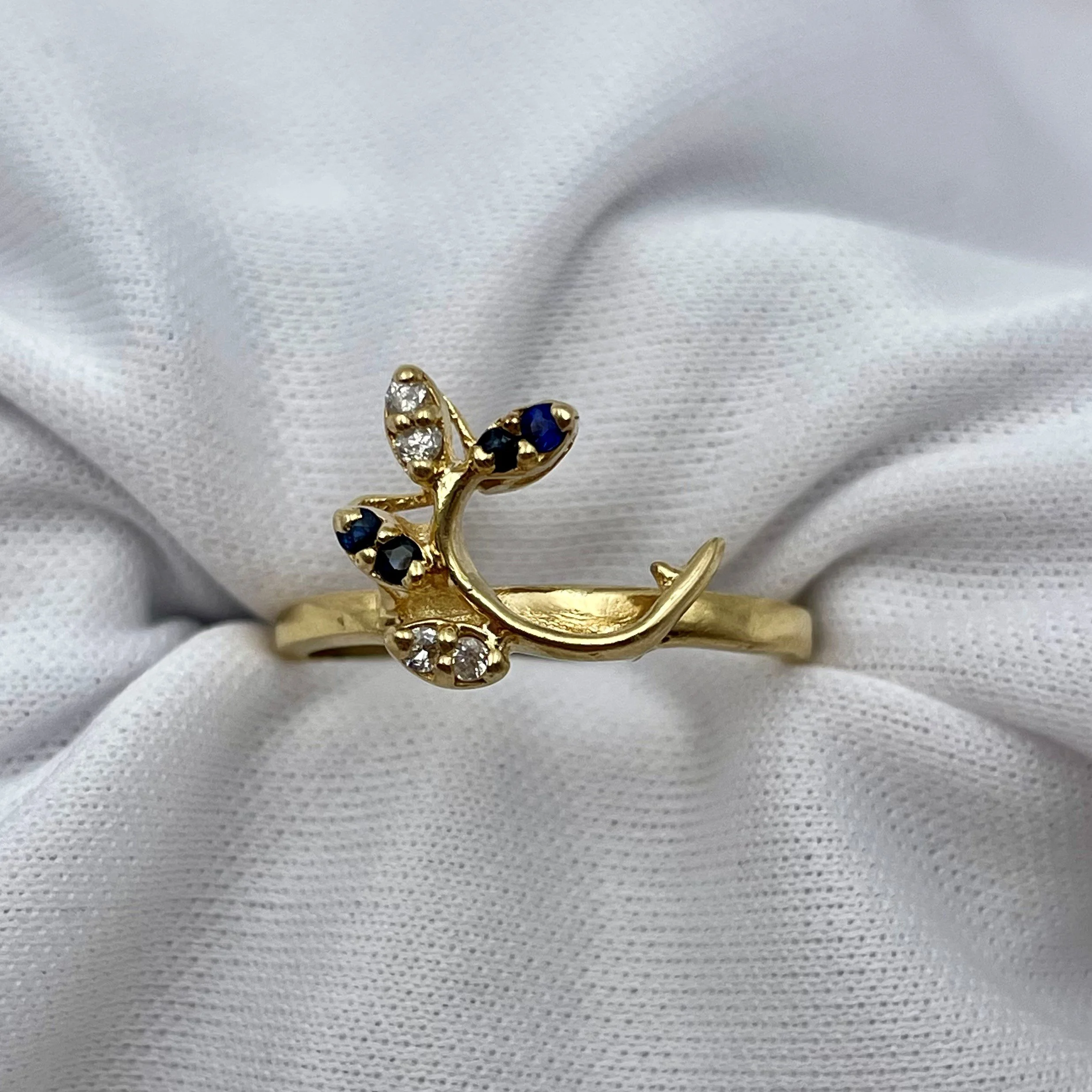 top down view of 14k Yellow Gold Sapphire And Diamond Leaf Wrap Wedding Band white background