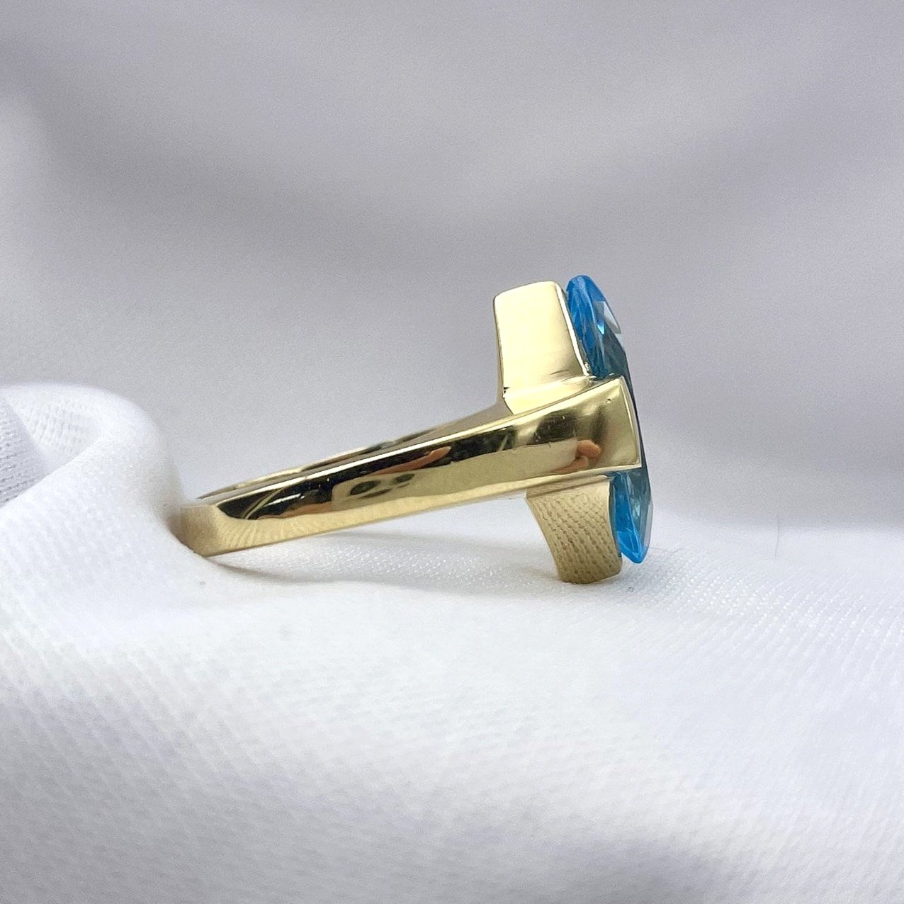 side view white background Marquise Cut Blue Topaz Solitaire Ladies Ring 14k Yellow gold