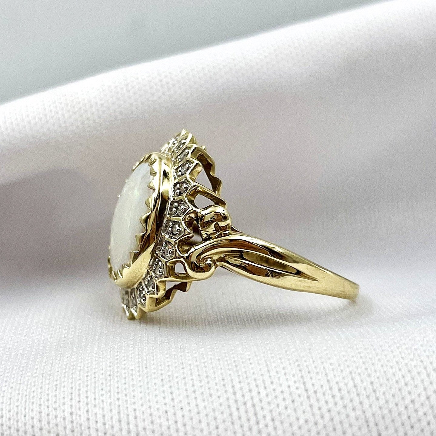 side view white background 3.01ct Oval Opal With Diamond Petal Halo 10k Yellow Gold Ring