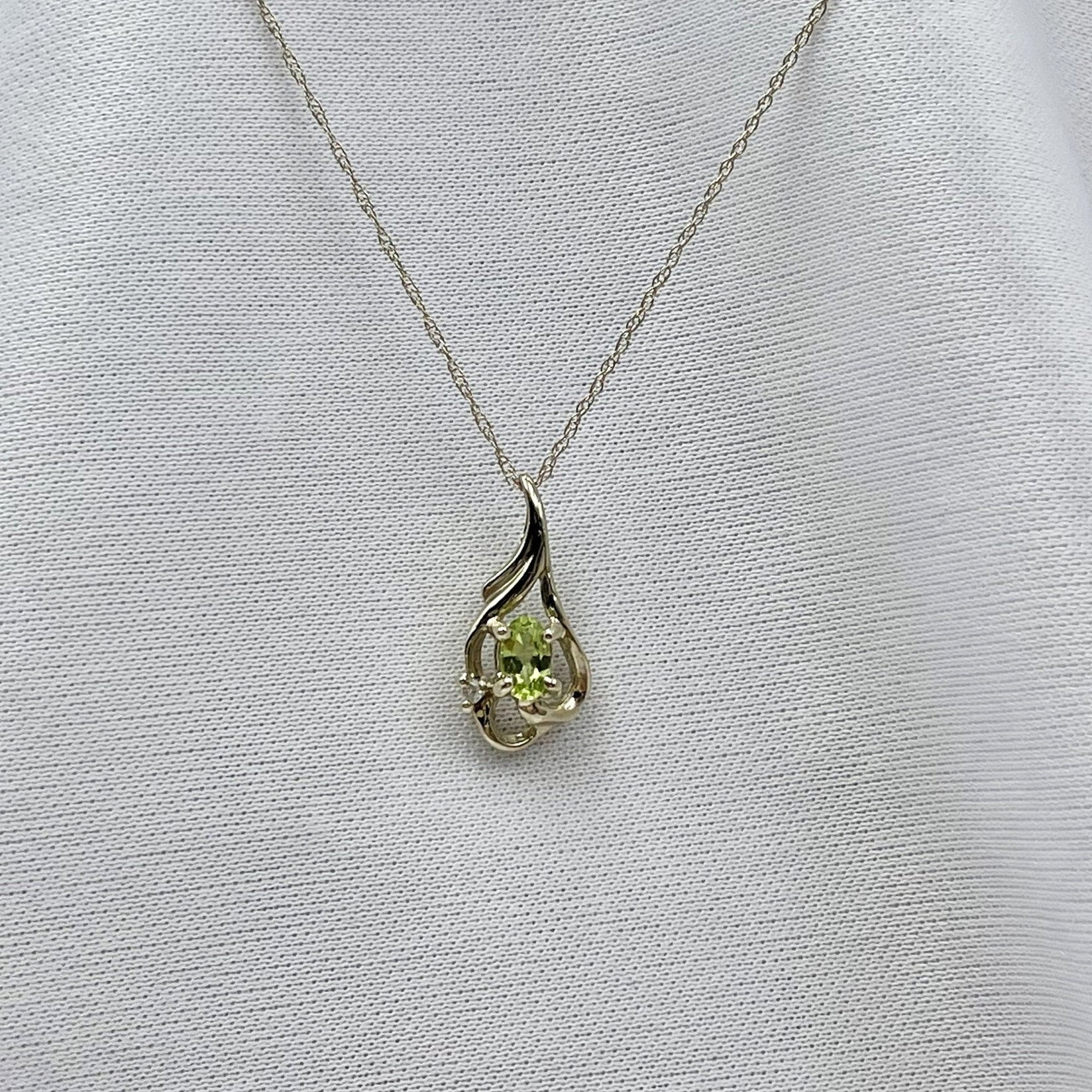 hanging on chain white background Oval Peridot With Diamond Accent Filigree Pendant 14k White Gold