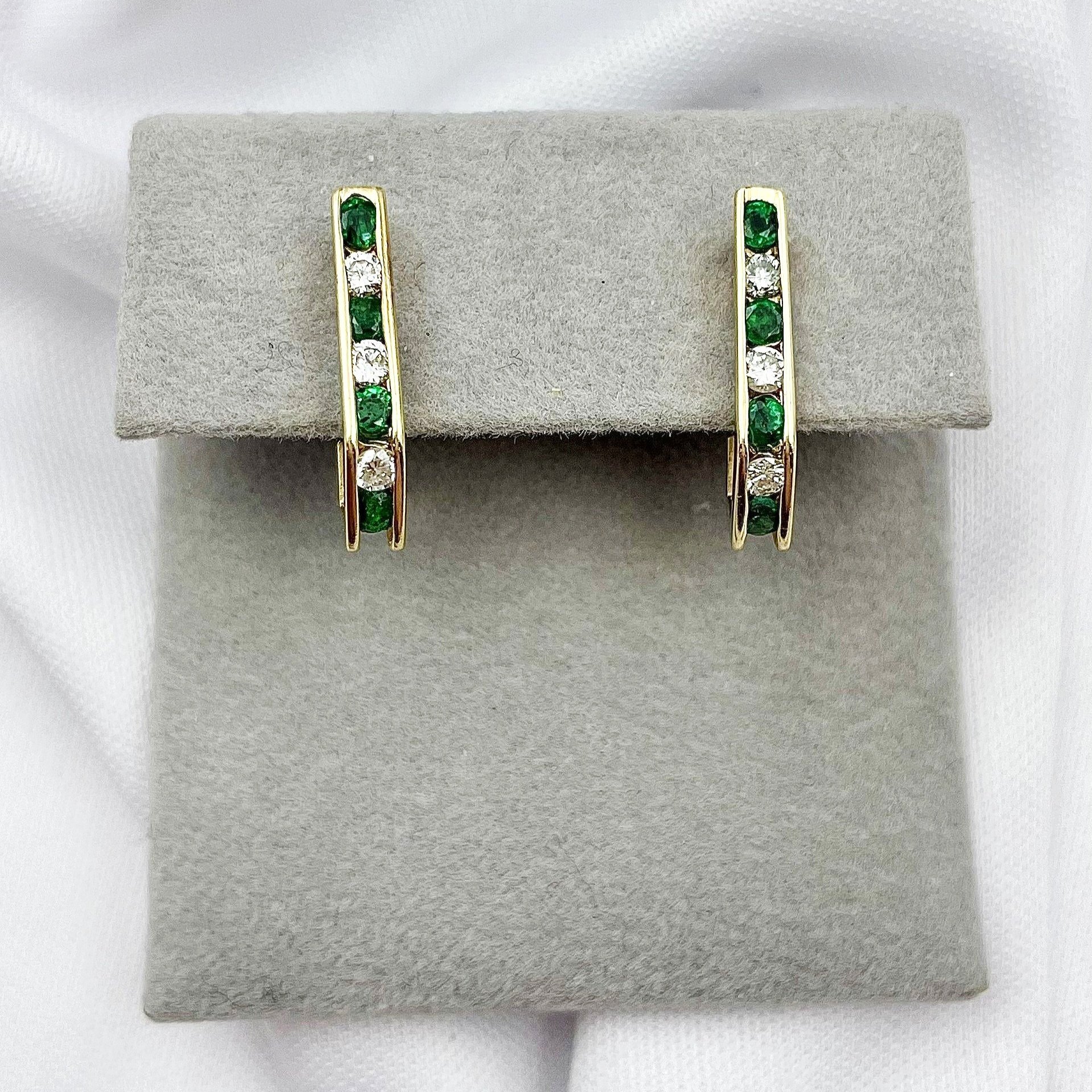 top down view white background 14k Yellow Gold Emerald And Diamond J Hoop Earrings