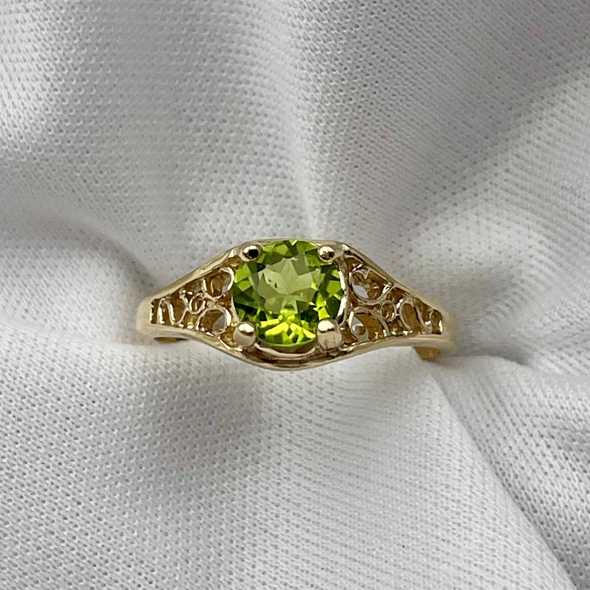 top down front view of 14k Yellow Gold 6mm Round Peridot With Filigree Shoulders Ladies Ring with white background