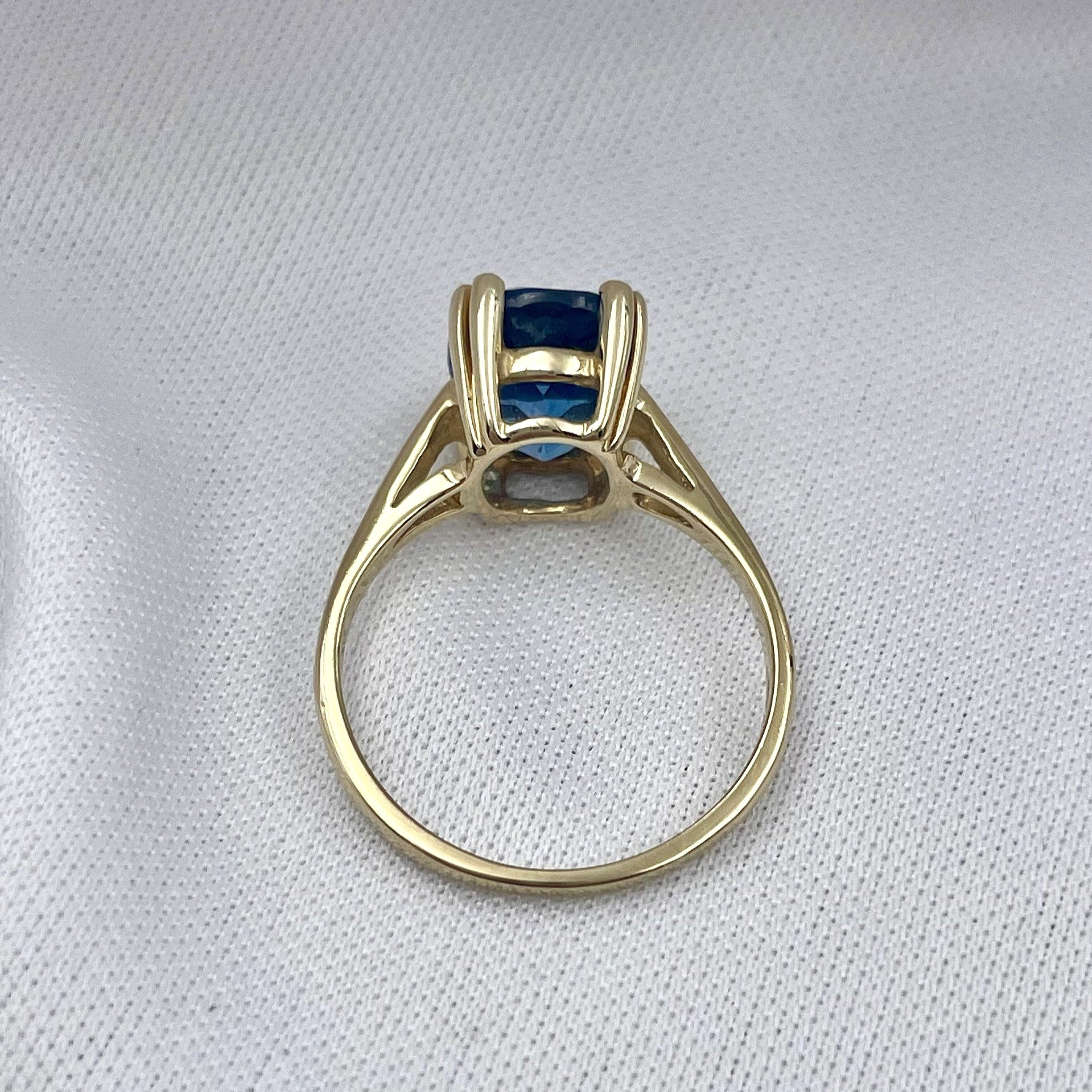 top down gallery view white background Oval Cut Blue Topaz Solitaire Ladies Ring 14k Yellow Gold