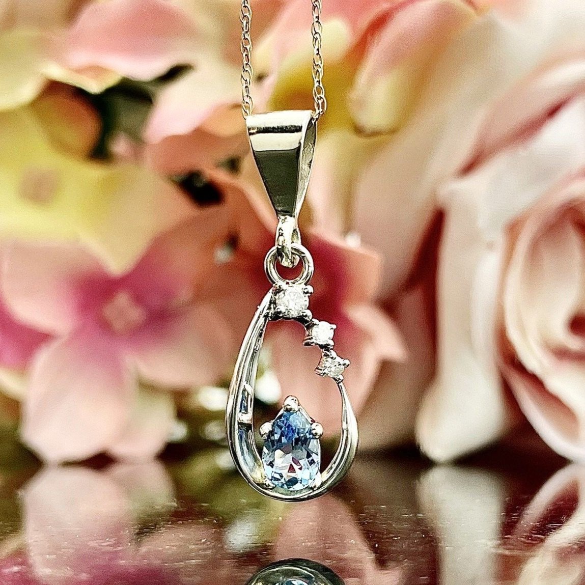 close up in front of flowers 14k White Gold Drop Pendant Pear Aquamarine With Diamonds Accents