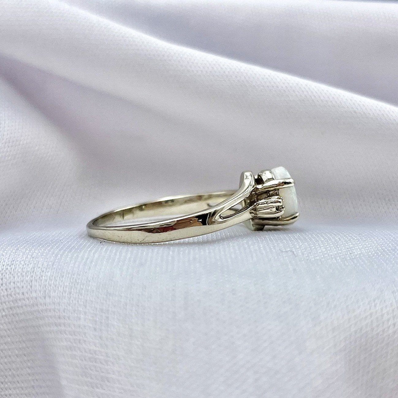 side view white background 10k White Gold Oval Opal With Diamond Accents Three Stone Ring
