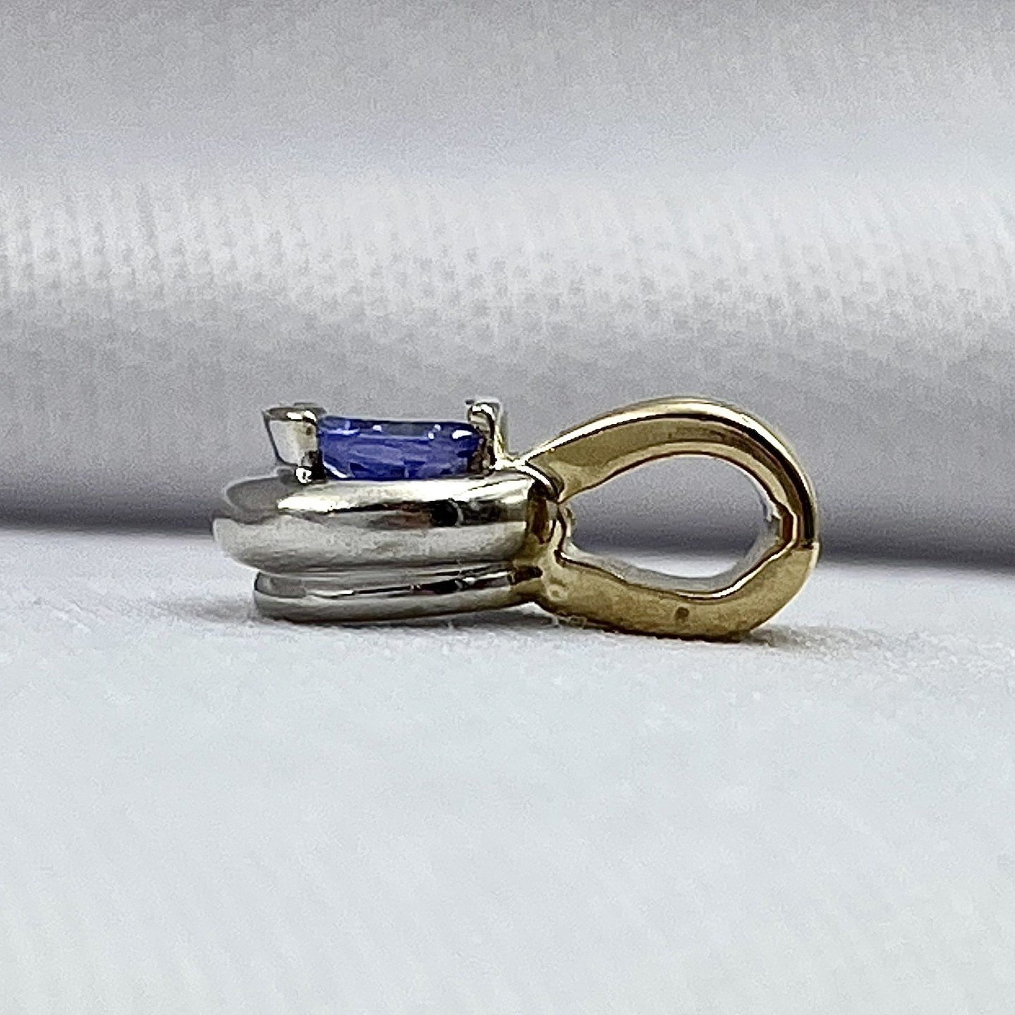 side view white background 14k Two Tone White And Yellow Gold Half Bezel Set Tanzanite Solitaire Pendant