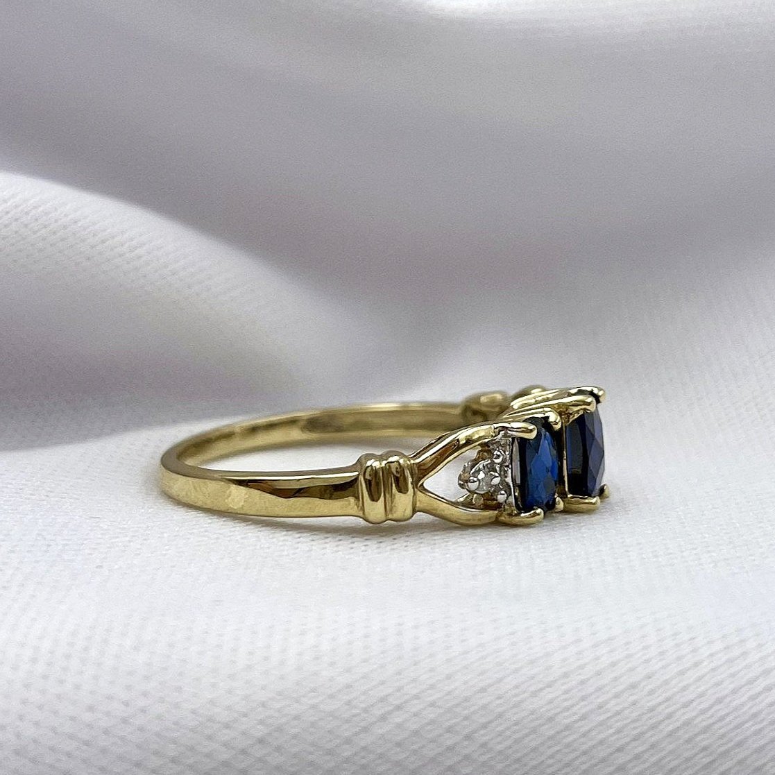 side view white background Synthetic Sapphires Oval Checkerboard Cut Three Stone 10k Yellow Gold Ring