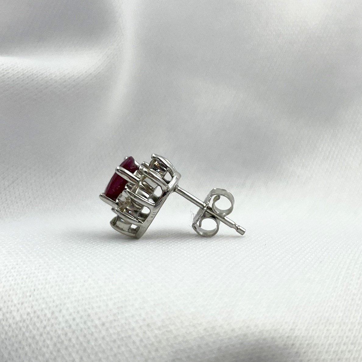 side view white background 14k White Gold 1 1/4ctw Oval Rubies With .44ctw Diamond Halos Stud Earrings