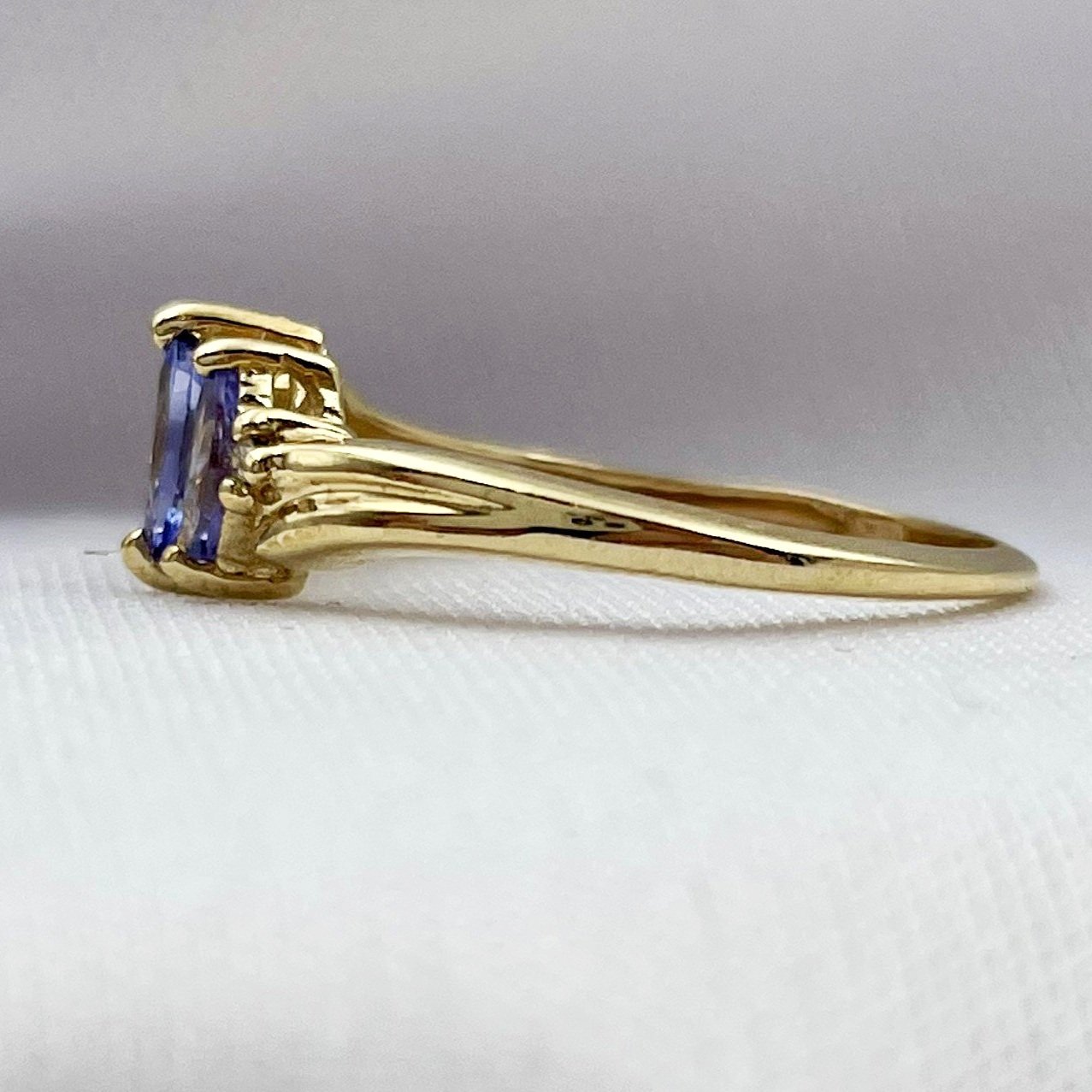 side view white background Marquise Cut Three Stone Tanzanite Ring With Diamond Accents 10k Yellow Gold