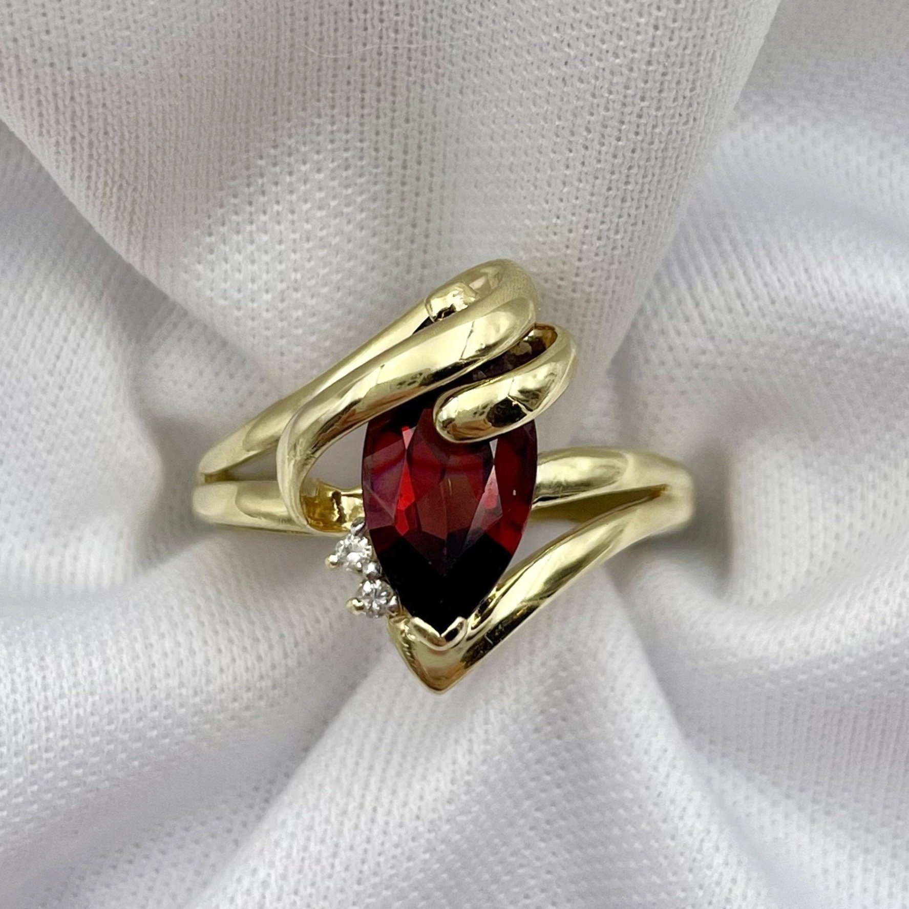 top down white background 10k Yellow Gold Marquise Garnet With Diamond Accents Ladies Ring