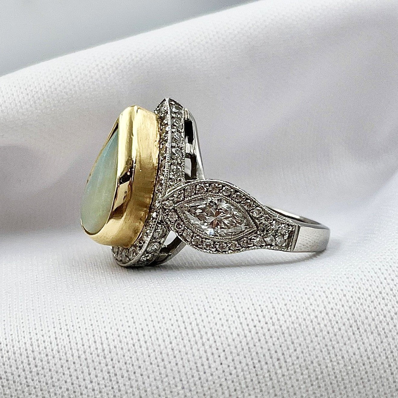 side view white background 3.01ct Pear Cabochon Bezel Set With 1.87ctw Diamond Accents in Two Tone 14k White 18k Yellow Ring
