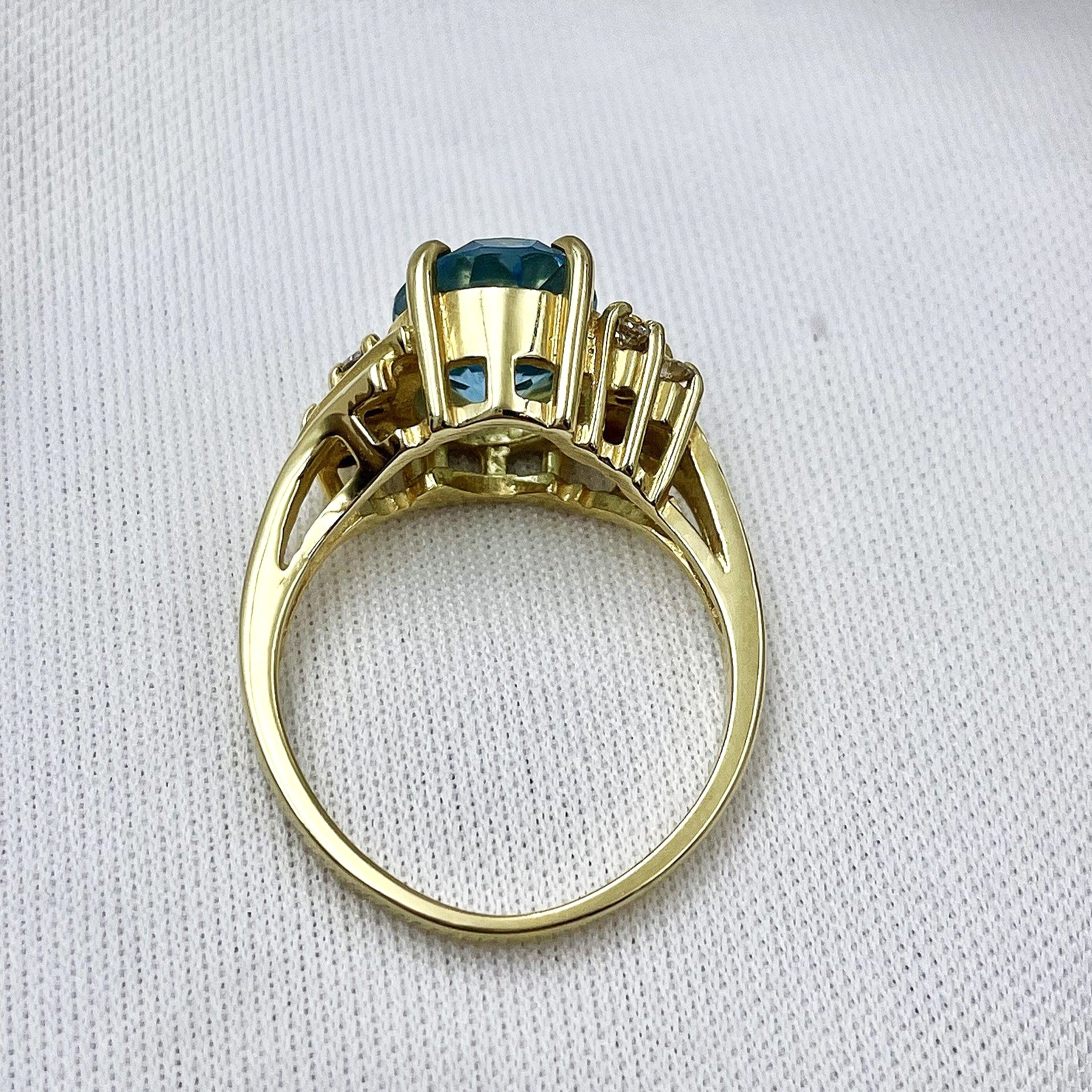 top down gallery view 14k Yellow Gold Oval Cut Blue Topaz With Diamond Accents Ladies Bypass Ring