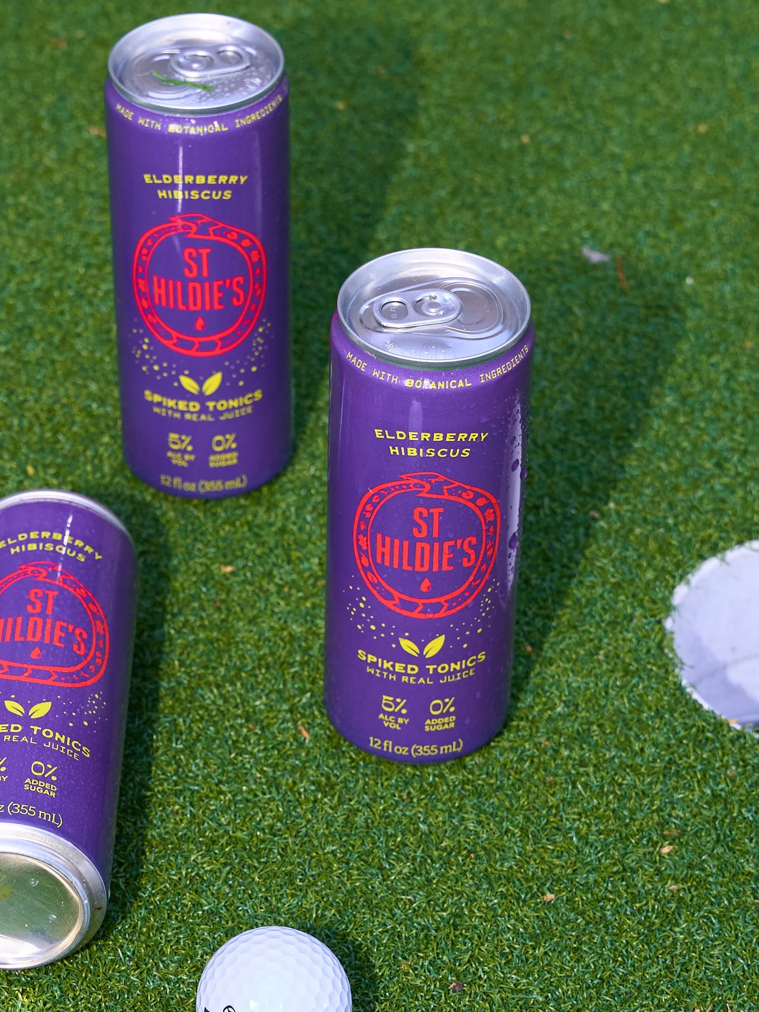 St Hildie's sparkling beverage cans on grass, product beverage photography by Golden Joy Photography in Los Angeles
