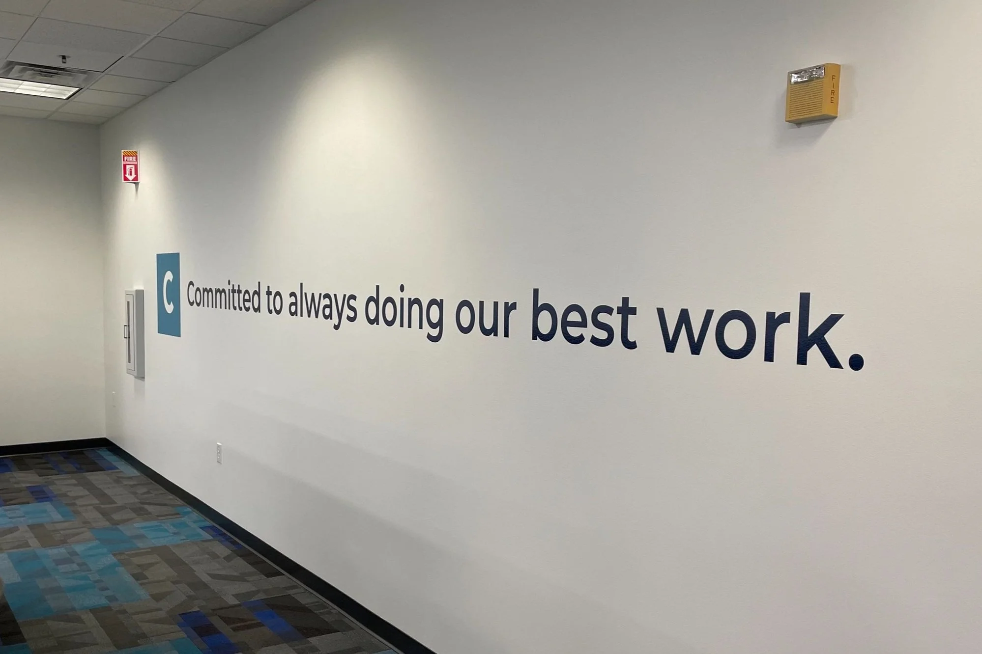 Vinyl graphics of core values on office walls.
