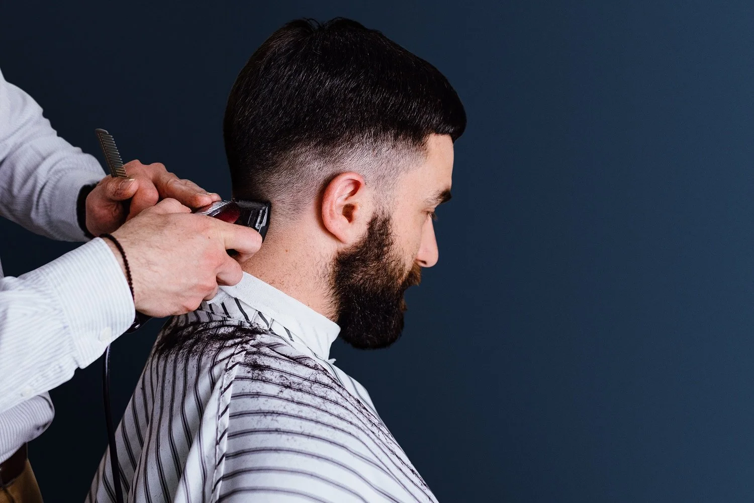 Barber giving a client a haircut