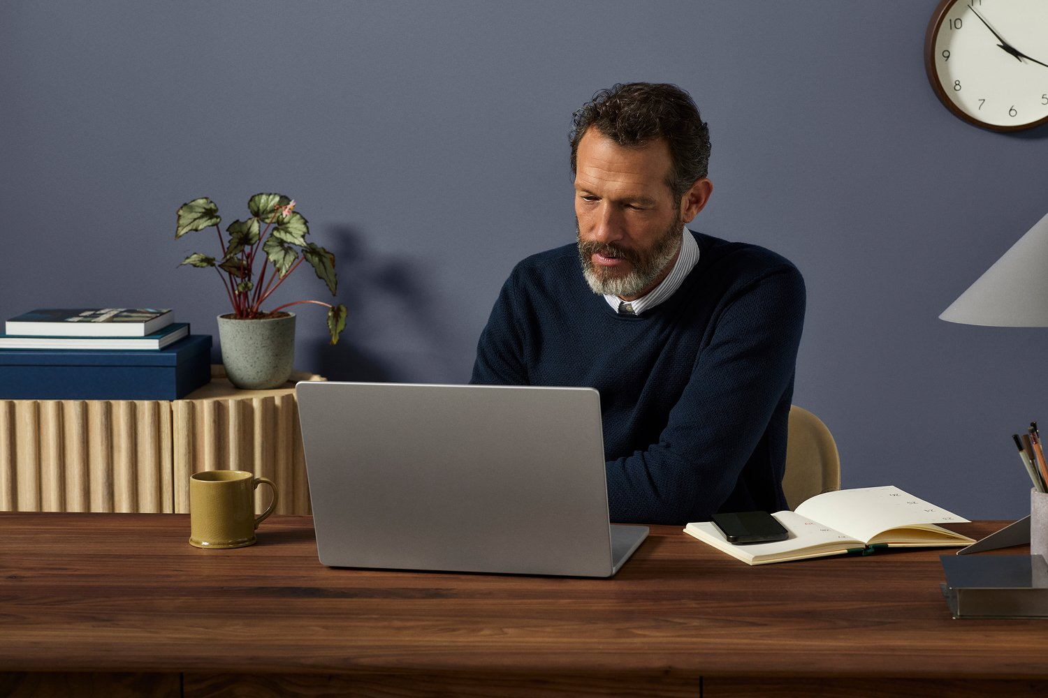 Man scheduling on laptop at desk