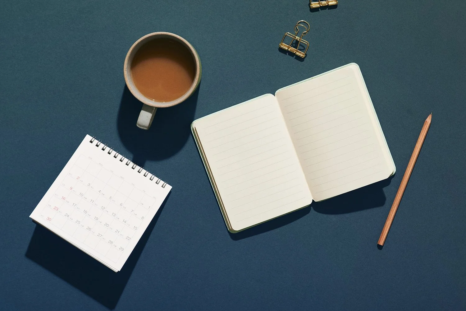 Calendar and notebook open on desk