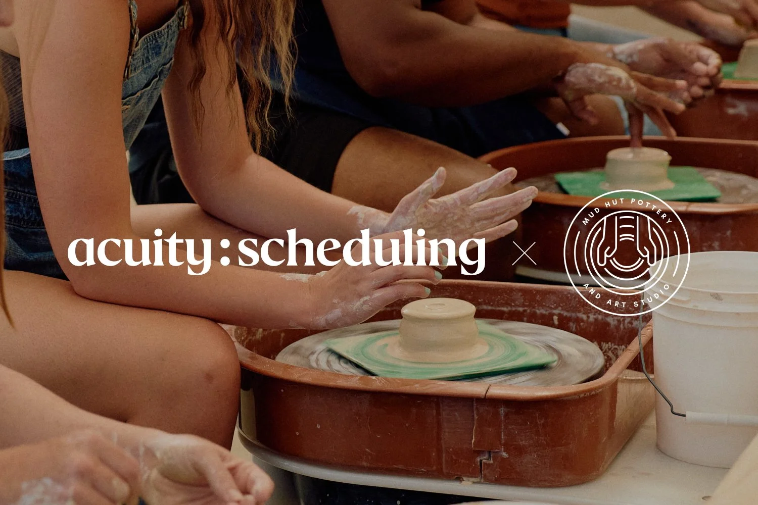 Hands shaping clay on a wheel with Mud Hut Pottery Studio and Acuity Scheduling logos