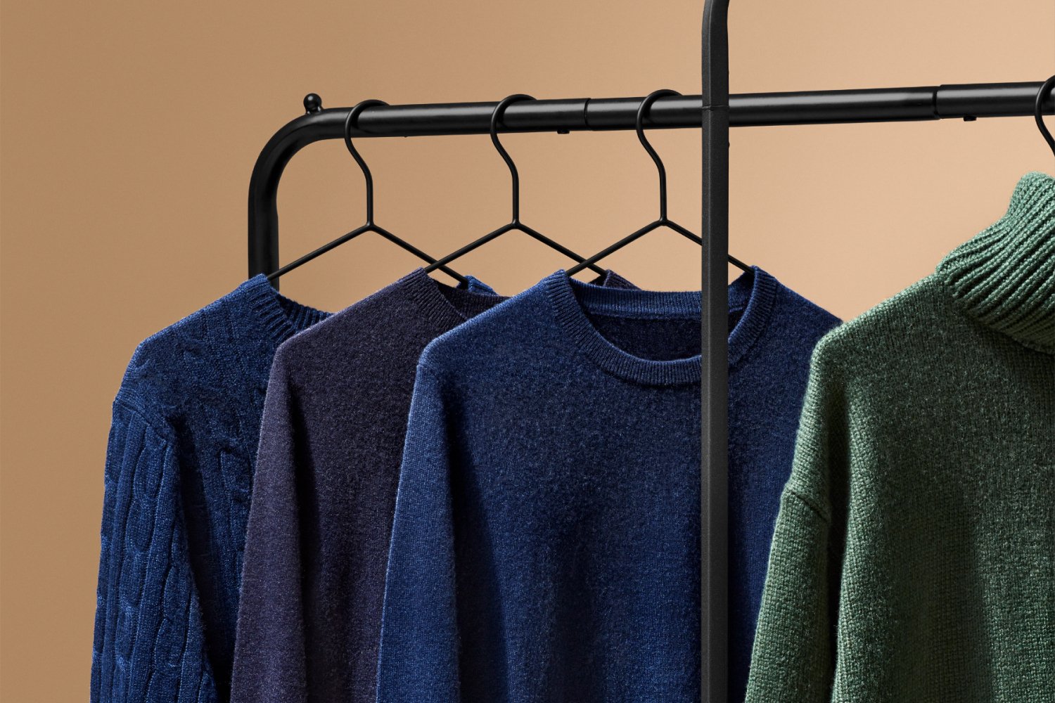 Sweaters hanging on clothing rack