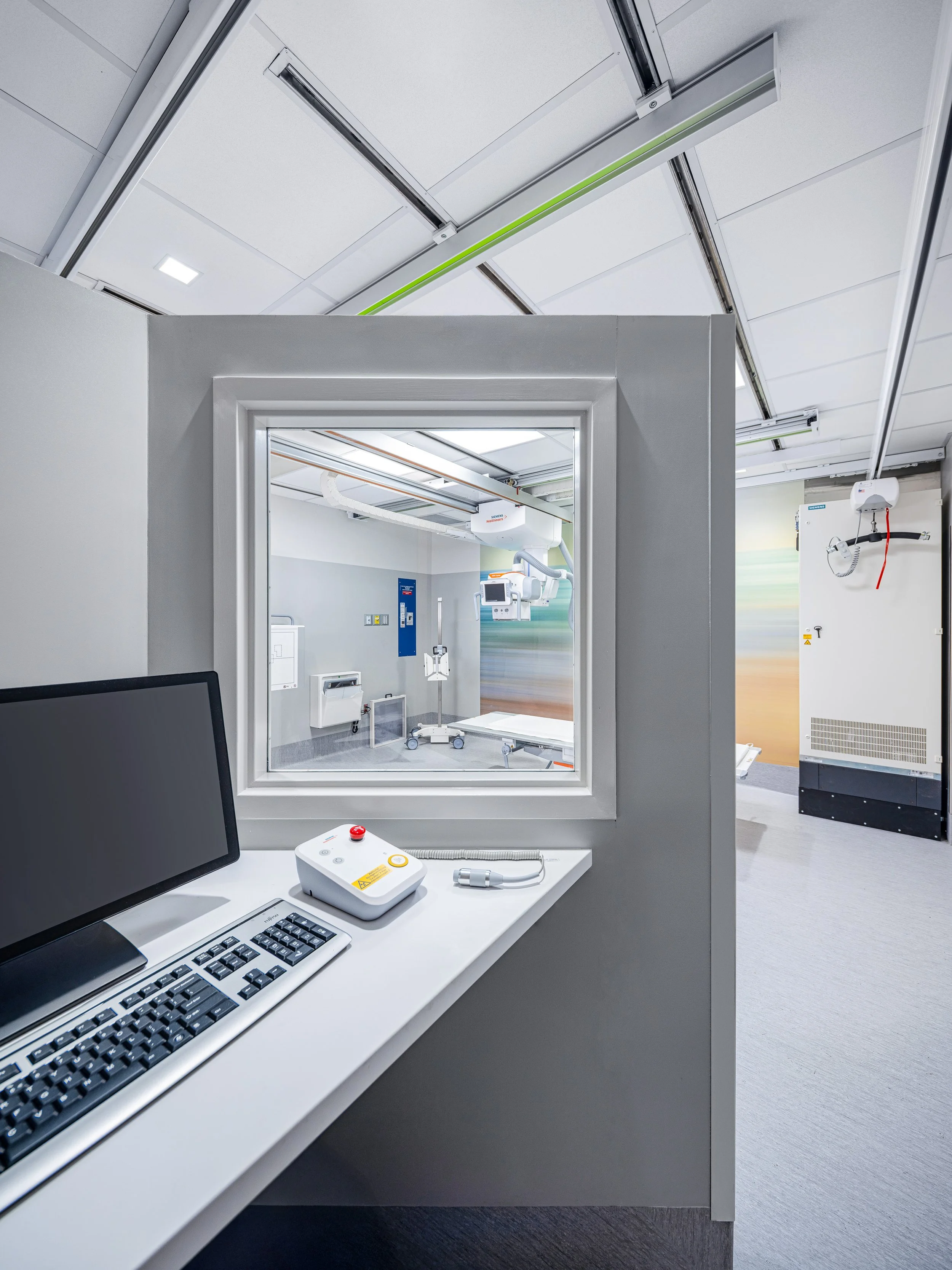 View toward the technologist control area illustrating clear sightlines, intuitive circulation, and thoughtful spatial organization. The design prioritizes workflow efficiency and safety, supporting clinical staff while maintaining a calm and profess