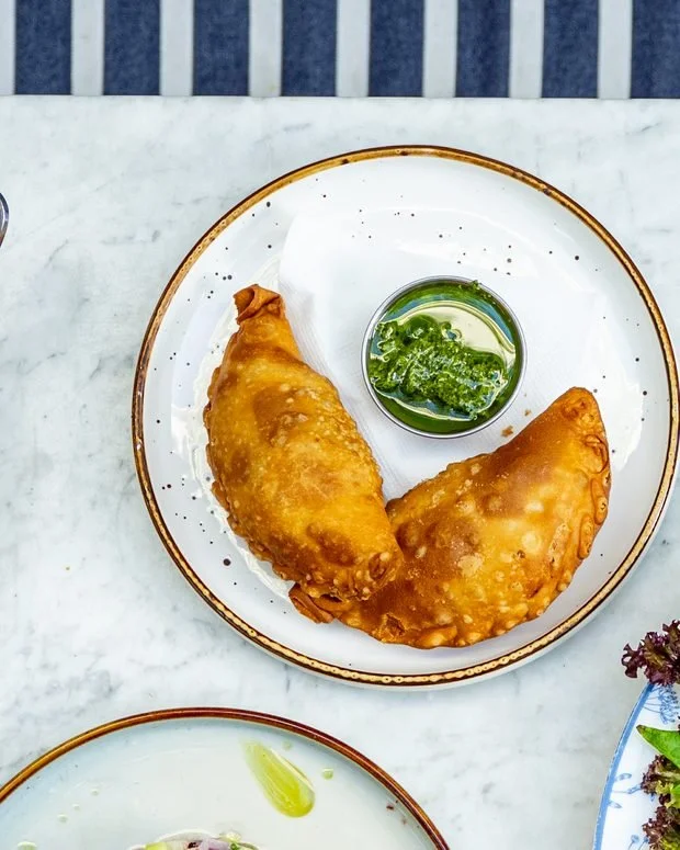 Golden empanadas with herb dipping sauce