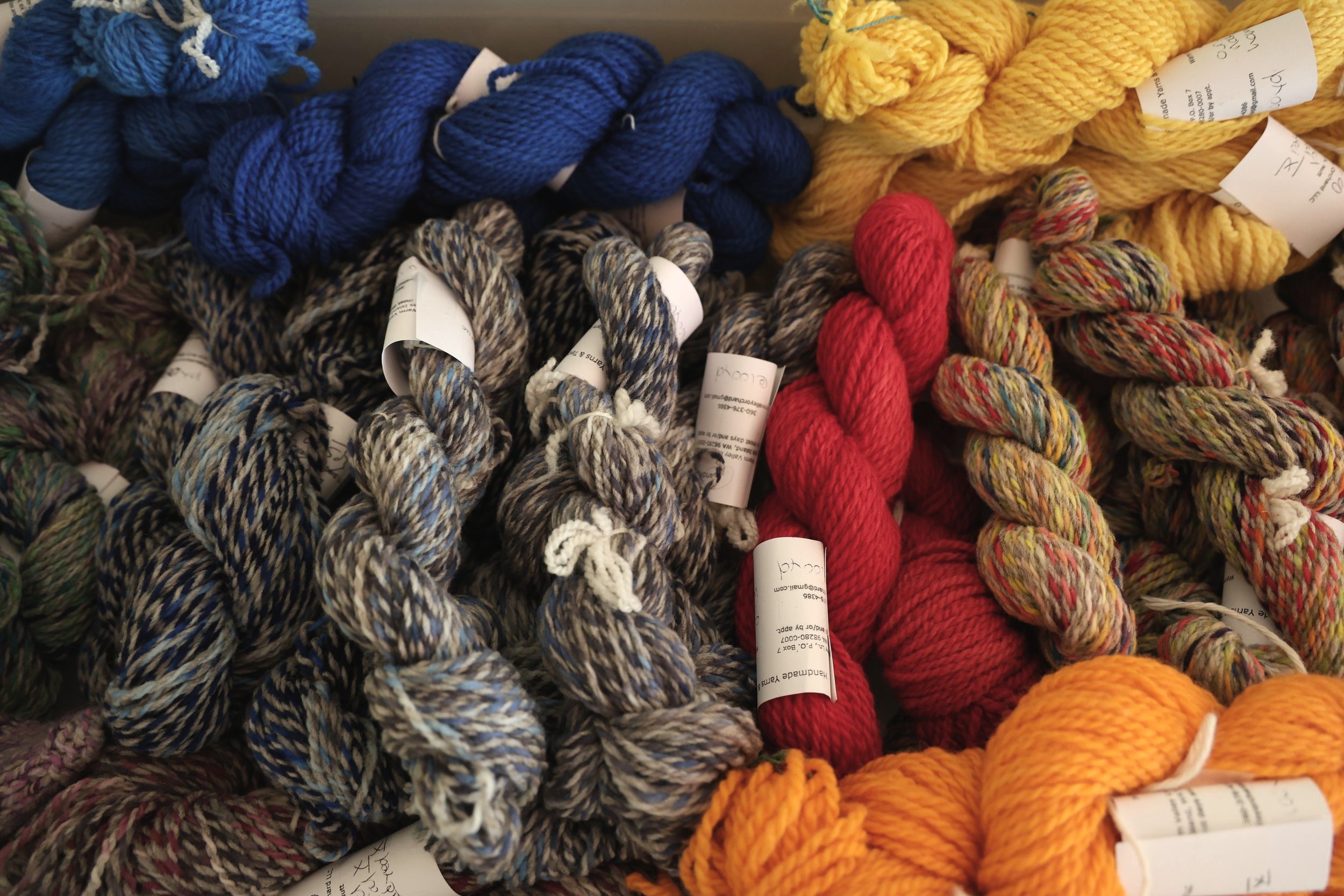 many colors of yarn together in a bin