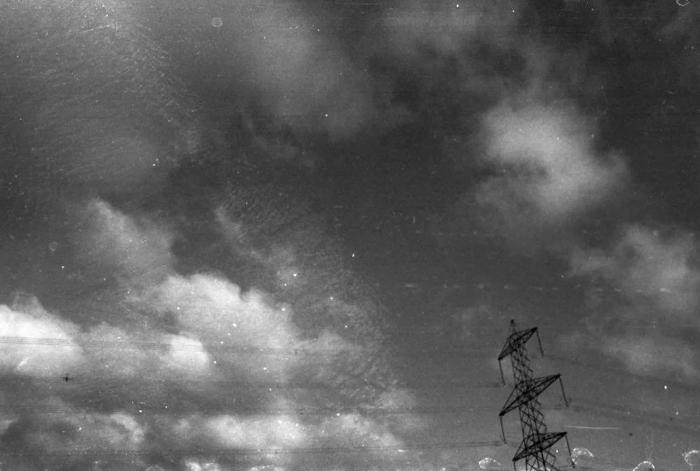 Black and white film photo of a pylon